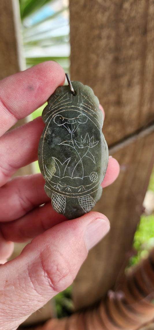 Vintage Oriental double sided carved Spinach Jade pendant featuring hand engraved Floral decorations and Chinese logographs characters.