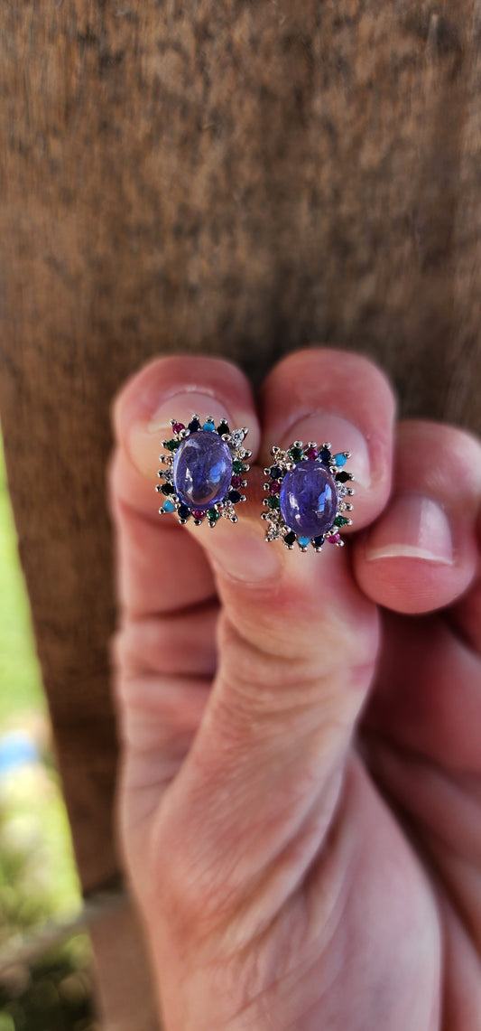 Extremely beautiful and elegant pair of Sterling Silver stud earrings - Each Earring claw set with an Natural Tanzanite Cabochon in the centre and surrounded by an muticolor Gemstones Haló frame.