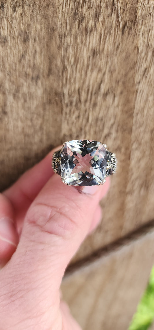 This alluring Sterling Silver cocktail/dress ring features an generous in size Cushion Cut Clear Quartz Gemstone,claw set in ornate floral motif claws.Marcasite studded Serpents adorn the shoulders/sides of the ring , guarding the Clear Quartz Gemstone.