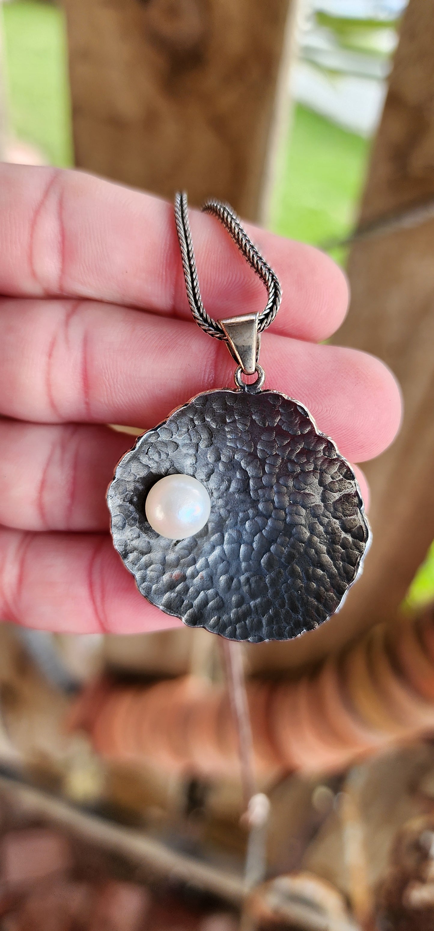 Unusual Artisan/Studio made Sterling Silver Modernist/Brutalist textured/hammered concave Round pendant with an Cultured Pearl , oxidised with an lovely Black patina.Fitted on an Sterling Silver Foxtail chain.