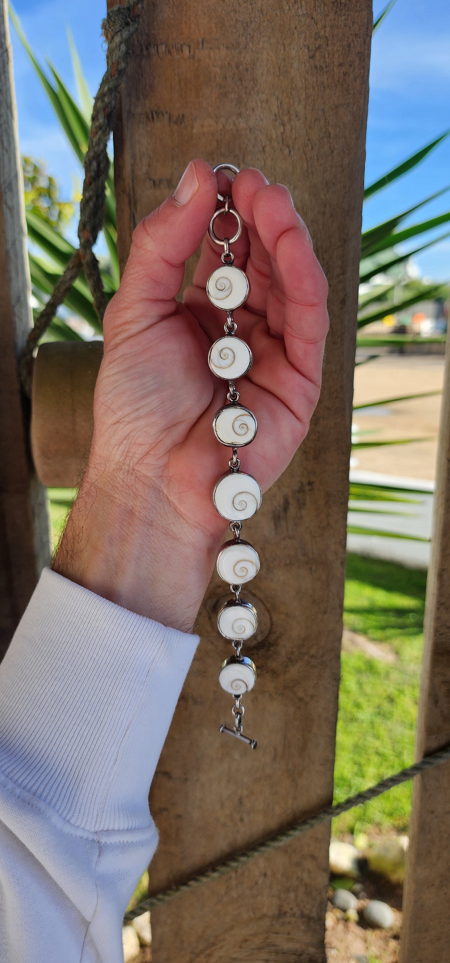 Sterling Silver and Operculum Spiral Shells "Shiva Eye" bracelet with matching Sterling Silver pendant on Sterling chain.