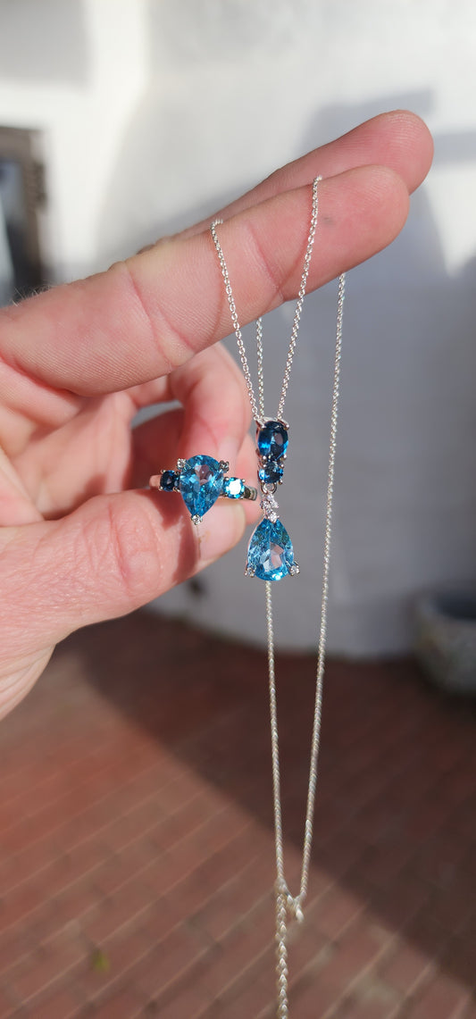 Matching set : Sterling Silver and Blue Topaz ring and pendant on chain.