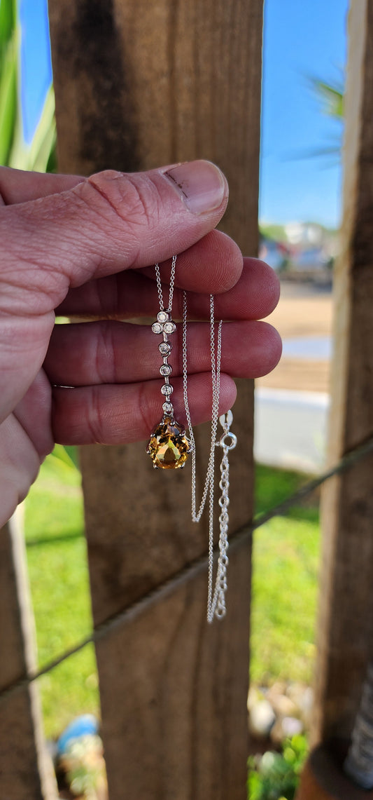 Absolutely stunning Art Deco inspired Sterling Silver pendant prong set with a Yellow Pear cut Citrine dangle suspended from a line drop of sparkly Round tube/bezel set CZ Gemstones,fitted on a adjustable Sterling Silver chain.