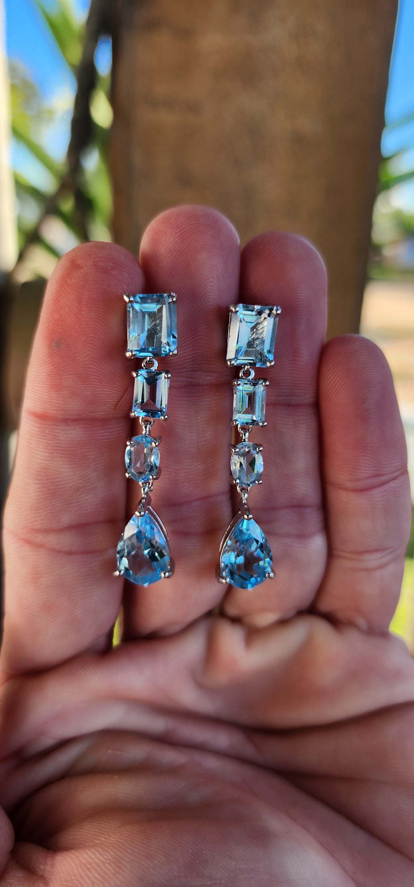 Beautiful pair of Sterling Silver and Topaz Gemstones push-in drop earrings .Each Claw set with a Pear Cut Topaz drop suspended from a line drop of 3x Rectangular and Oval Cut Topaz Gemstones.