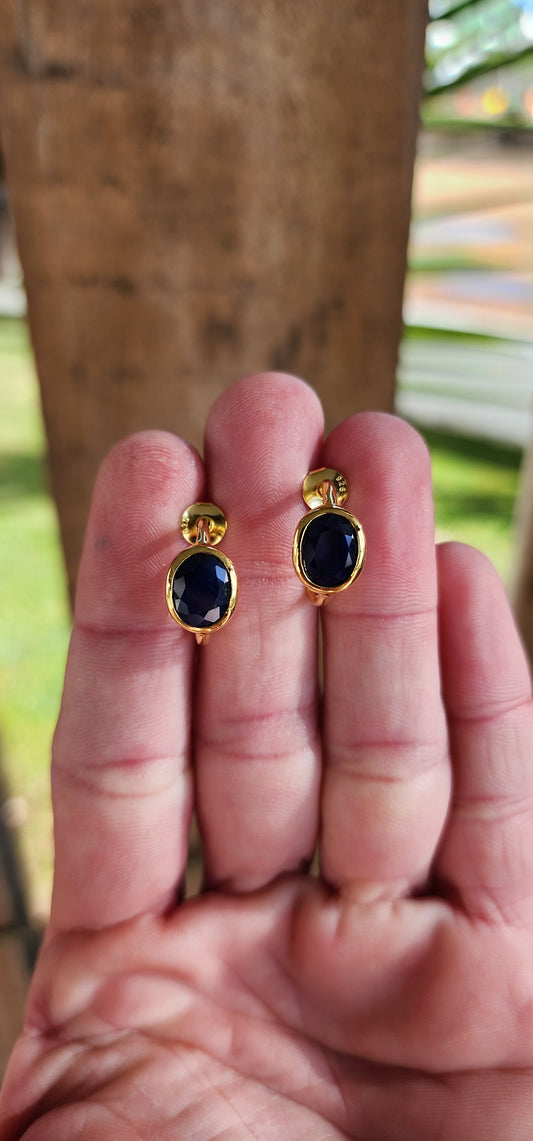 Modernist in style pair of Sterling Silver with 18ct Yellow Gold plating half hoop stud earrings - Each bezel/tube set with a generous in size Oval cut Blue Sapphire Gemstone.