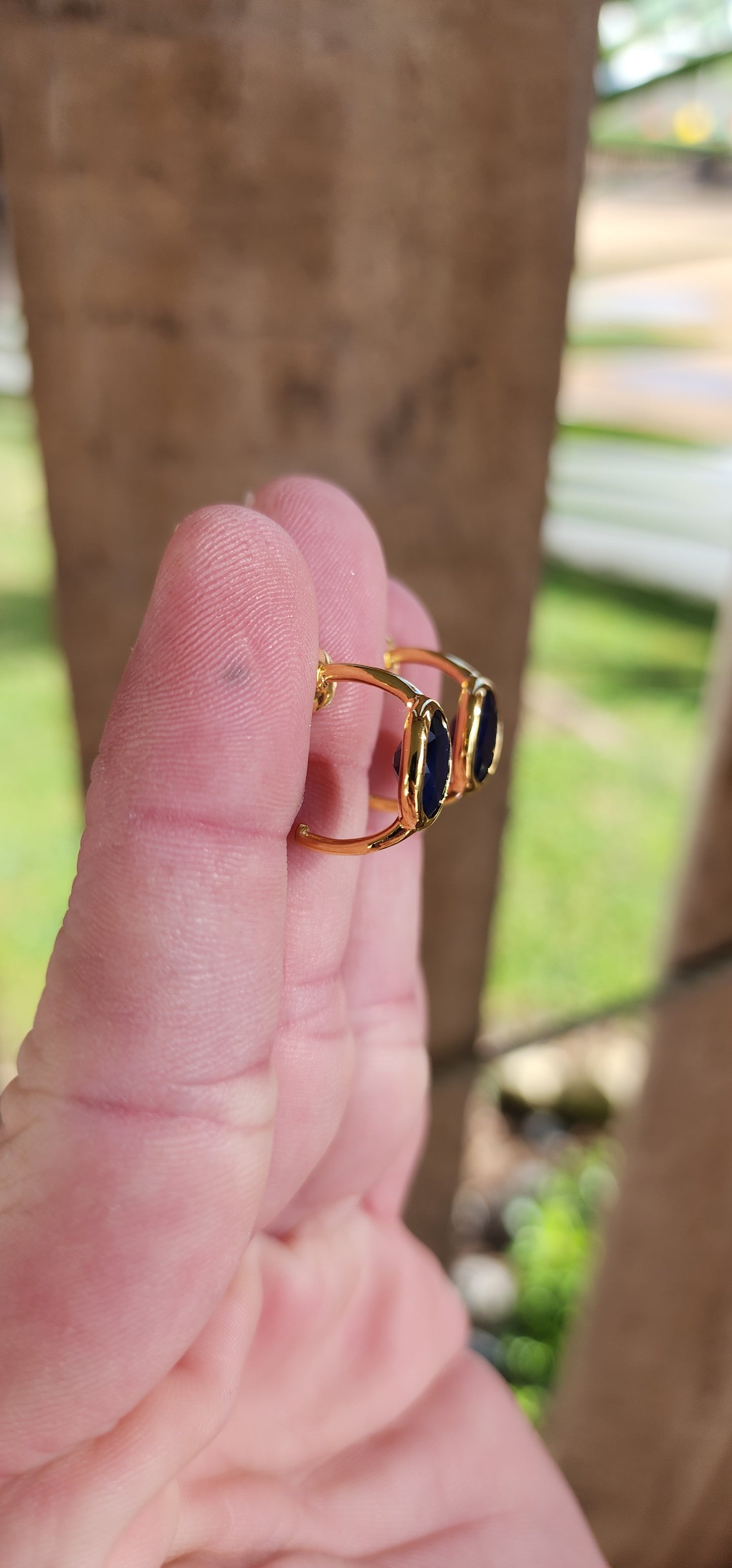 Modernist in style pair of Sterling Silver with 18ct Yellow Gold plating half hoop stud earrings - Each bezel/tube set with a generous in size Oval cut Blue Sapphire Gemstone.