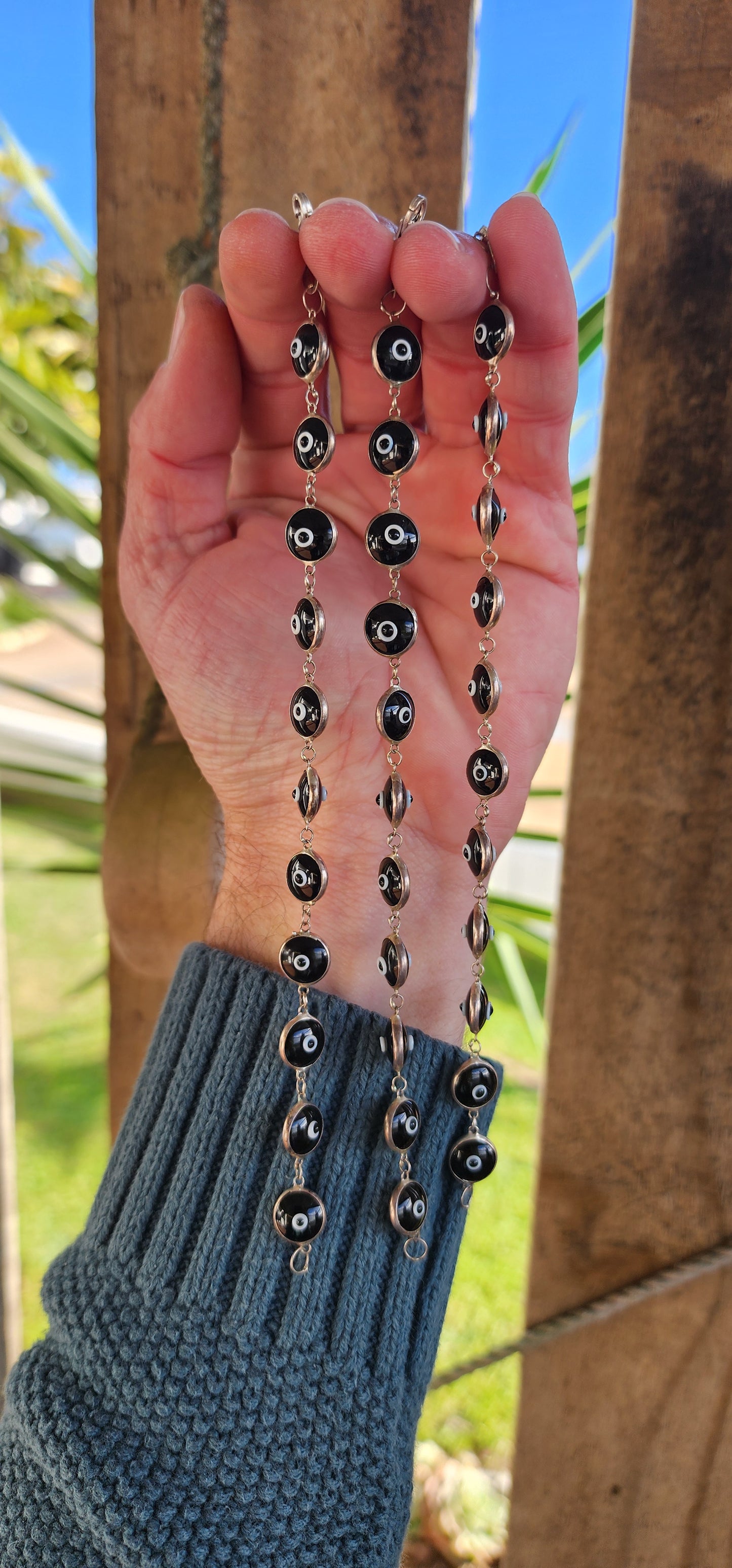 Sterling Silver bracelets featuring double sided Black and White Glass Evil Eye links.