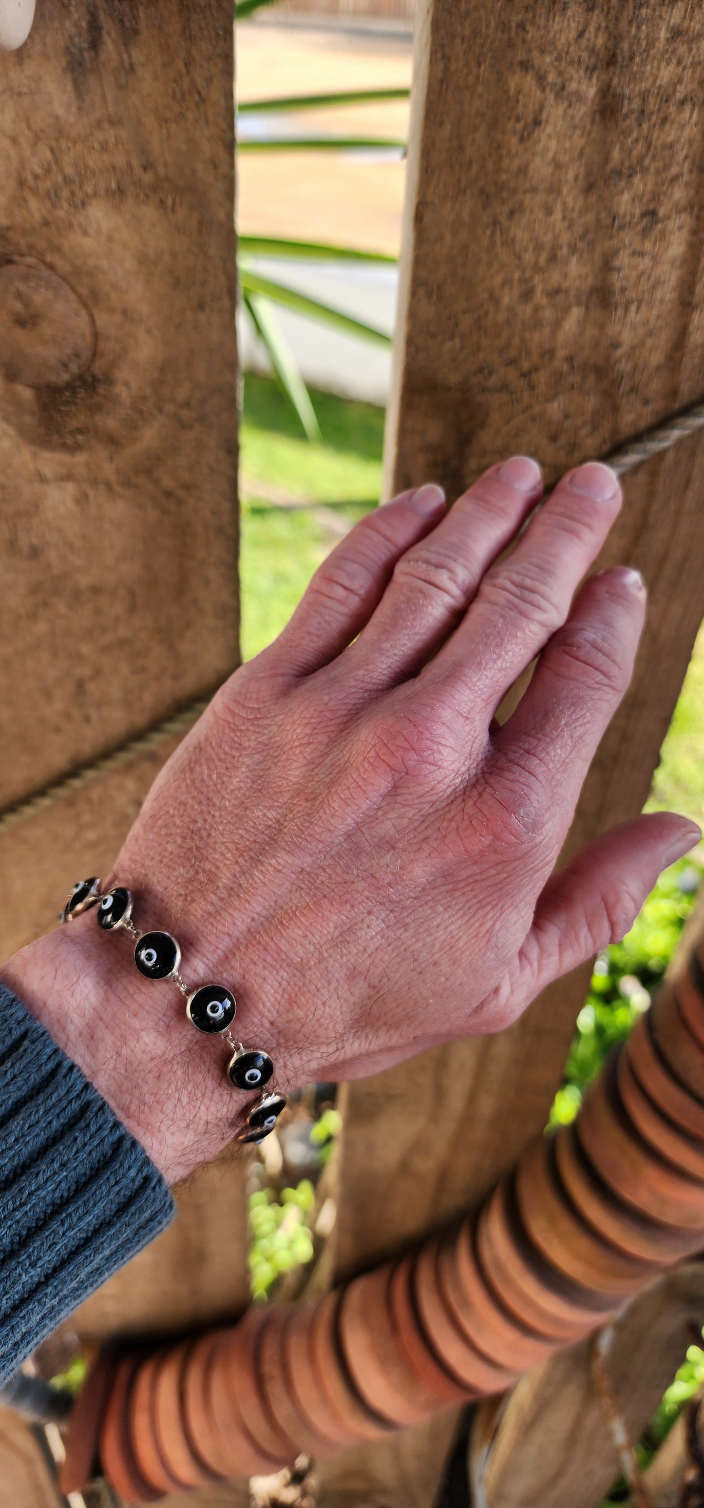 Sterling Silver bracelets featuring double sided Black and White Glass Evil Eye links.