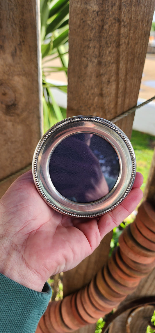 Hallmark Sterling Silver Circular shaped picture frame with original glass.
Made by Carrs of Sheffield Manufacturing Ltd Circa 2001 and Hallmarked accordingly.