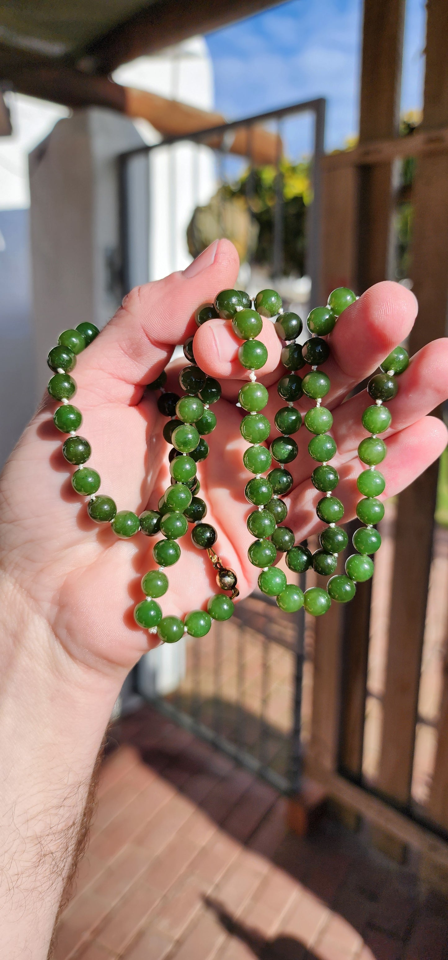 Marvelous Vintage extra length dark Green Nephrite "spinach" Jade beaded necklace, fitted with a 9ct Yellow Gold circular clasp.
These stunning beads are perfectly Round in shape and flaunt lovely shades of Green.