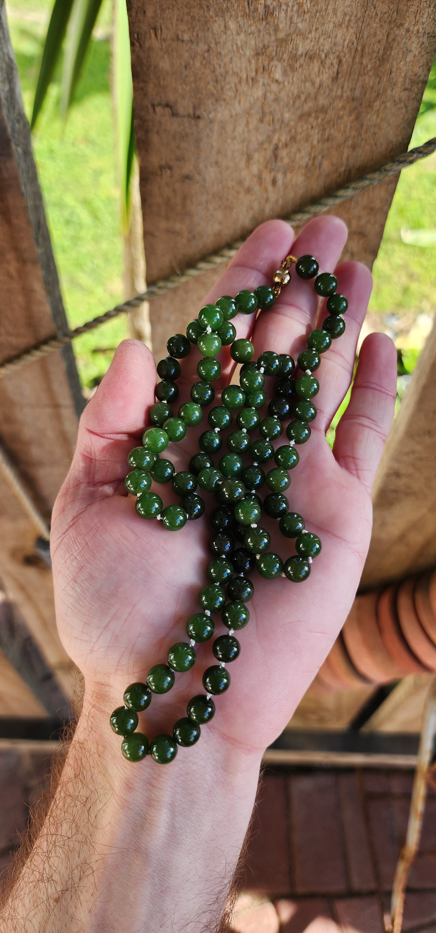 Marvelous Vintage extra length dark Green Nephrite "spinach" Jade beaded necklace, fitted with a 9ct Yellow Gold circular clasp.
These stunning beads are perfectly Round in shape and flaunt lovely shades of Green.