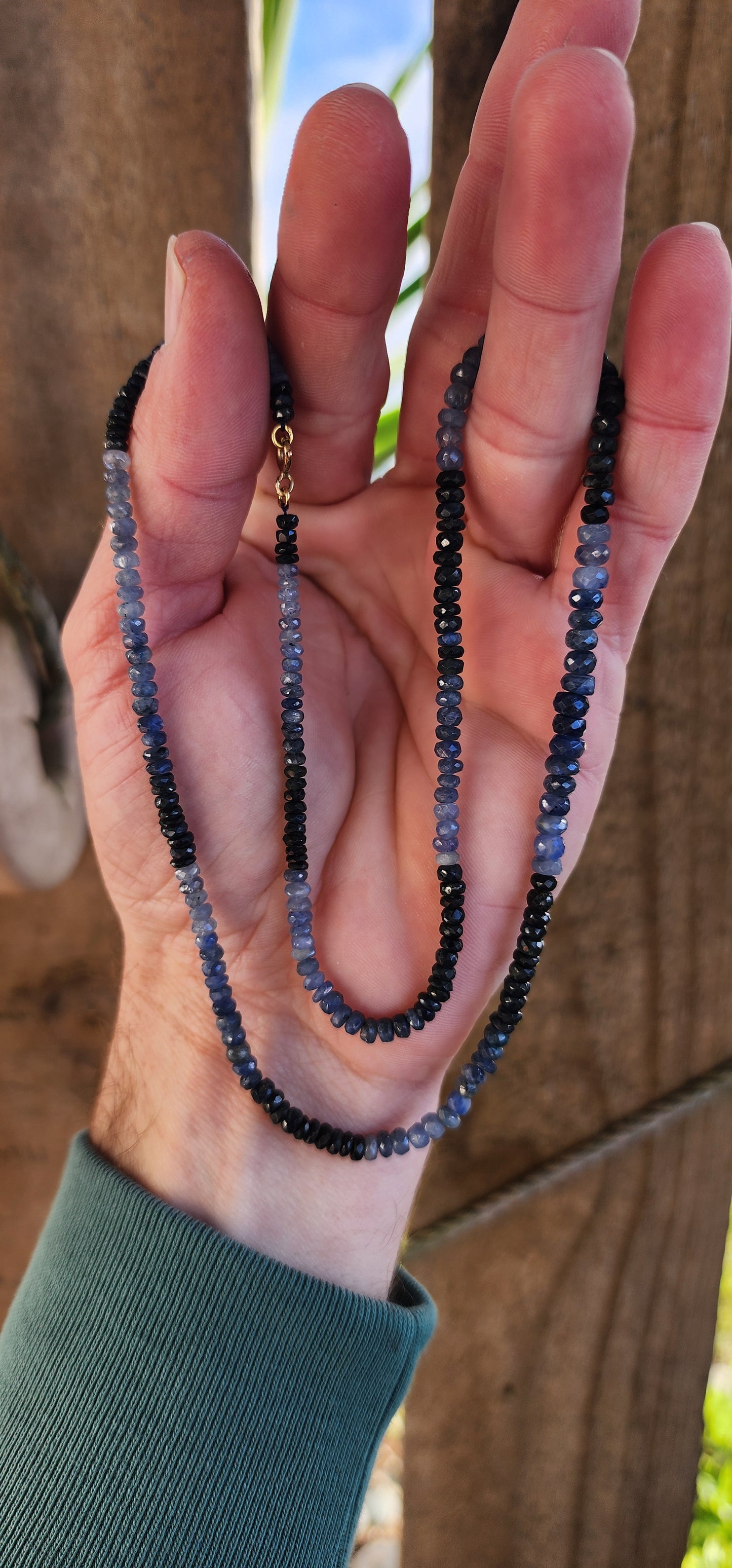 Beautiful and extra length necklace flaunting a delicious and sparkly collection of Natural faceted Ombre Sapphire Rondell beads in graduated size.The Sapphire beads colour range from soft powder Blue to intense midnight Blue.