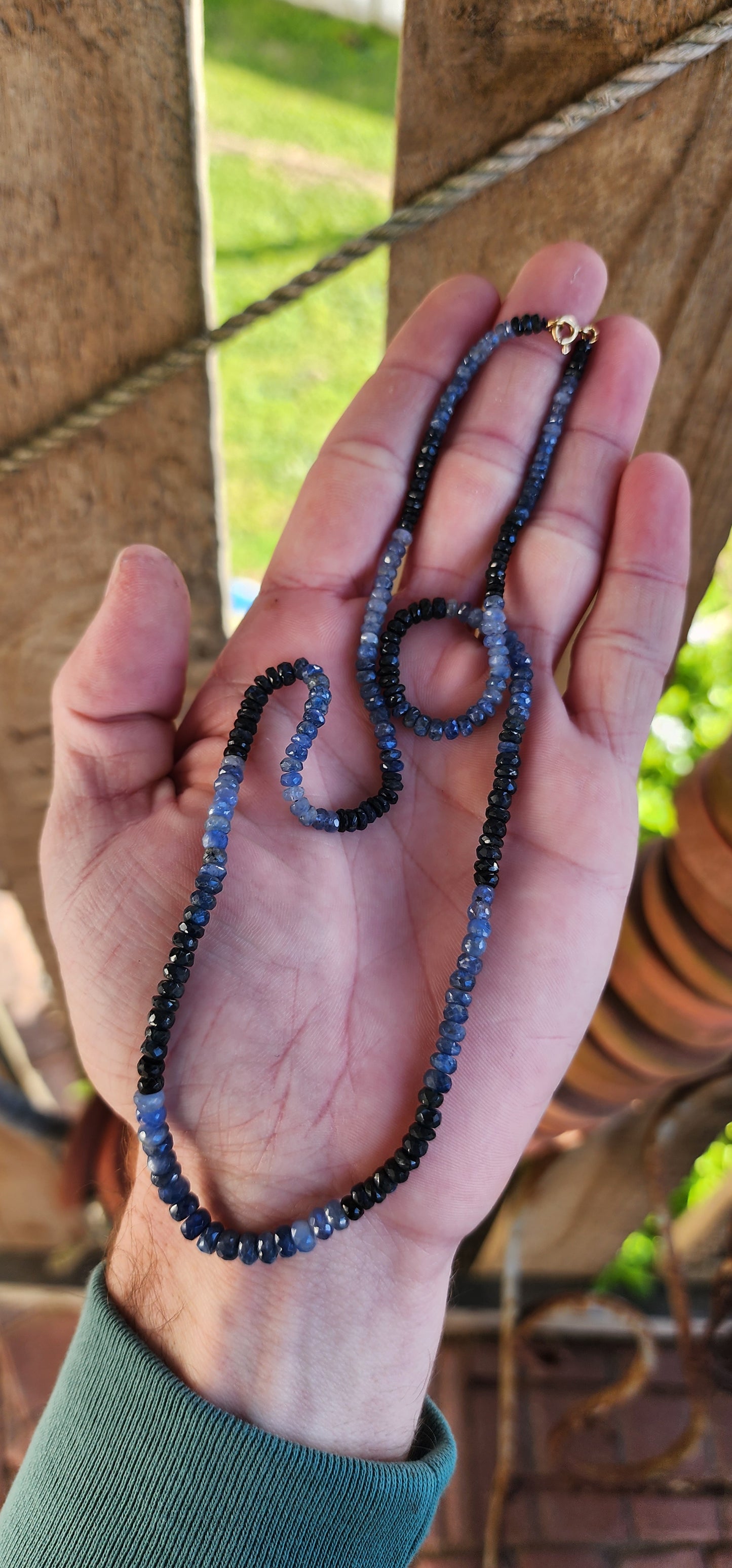 Beautiful and extra length necklace flaunting a delicious and sparkly collection of Natural faceted Ombre Sapphire Rondell beads in graduated size.The Sapphire beads colour range from soft powder Blue to intense midnight Blue.