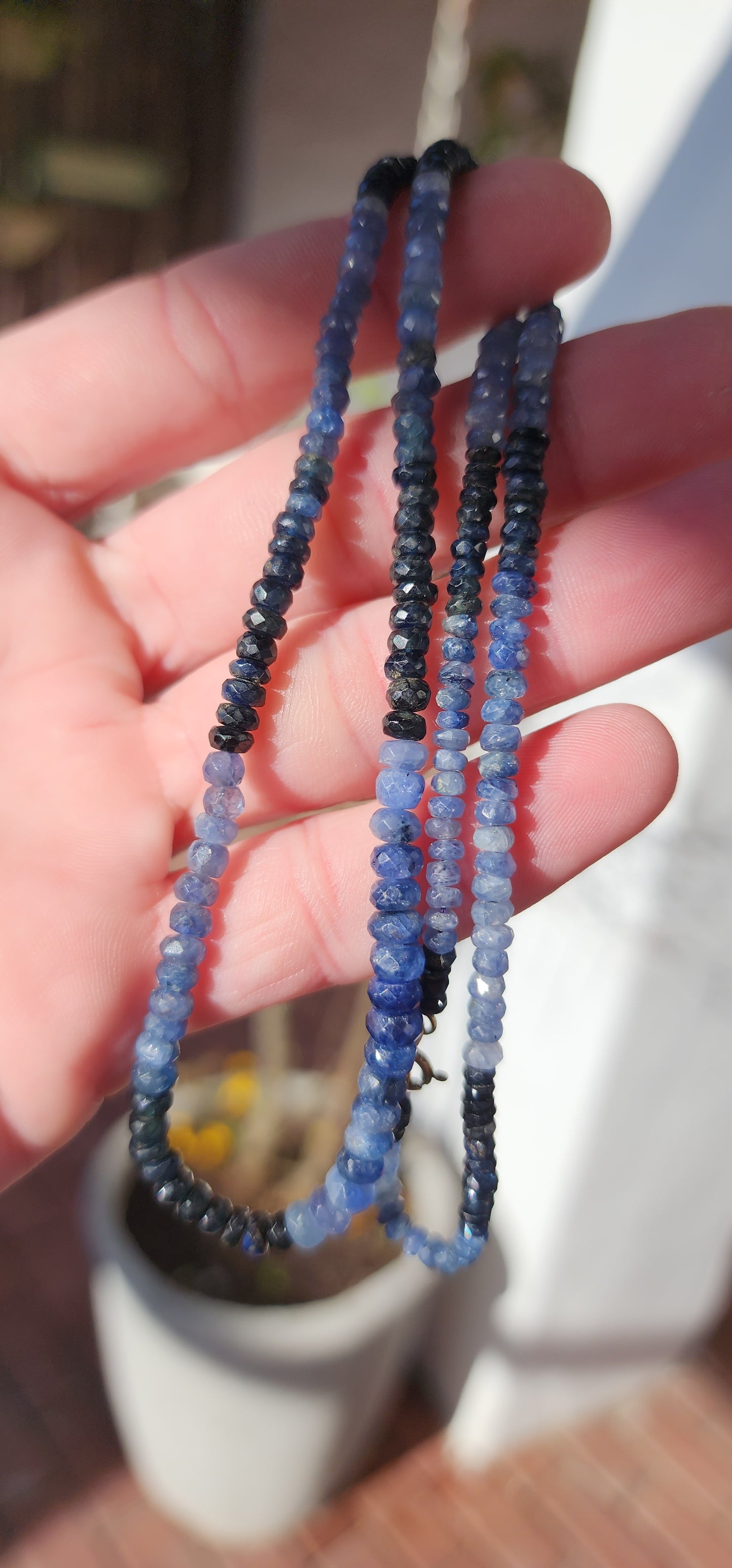 Beautiful and extra length necklace flaunting a delicious and sparkly collection of Natural faceted Ombre Sapphire Rondell beads in graduated size.The Sapphire beads colour range from soft powder Blue to intense midnight Blue.