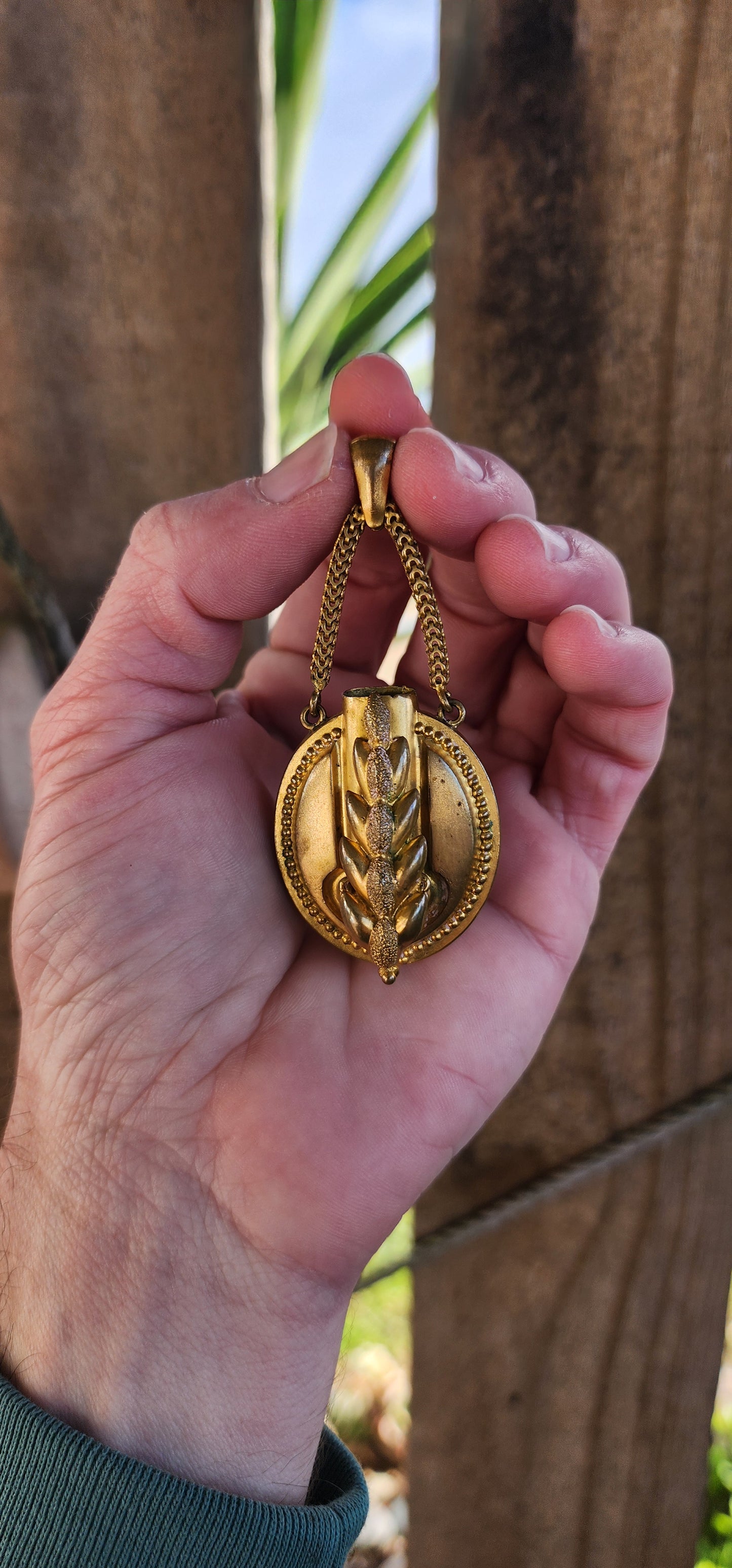 Antique Victorian Oval shaped Gold gilt over Brass Posy holder pendant suspended from two chains attached to the bail- The first Posy pendant ive ever come across. The front ornately decorated with a embossed Wheat grain.