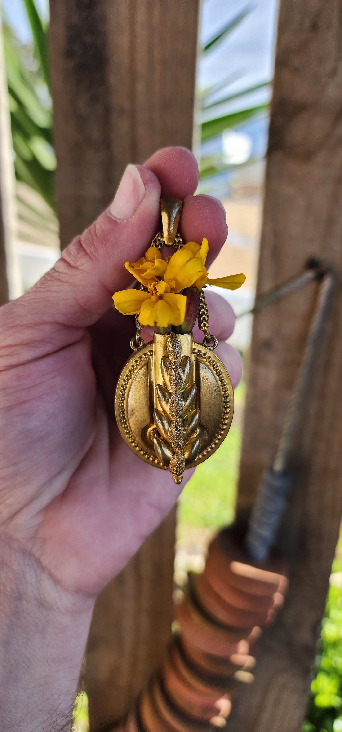 Antique Victorian Oval shaped Gold gilt over Brass Posy holder pendant suspended from two chains attached to the bail- The first Posy pendant ive ever come across. The front ornately decorated with a embossed Wheat grain.