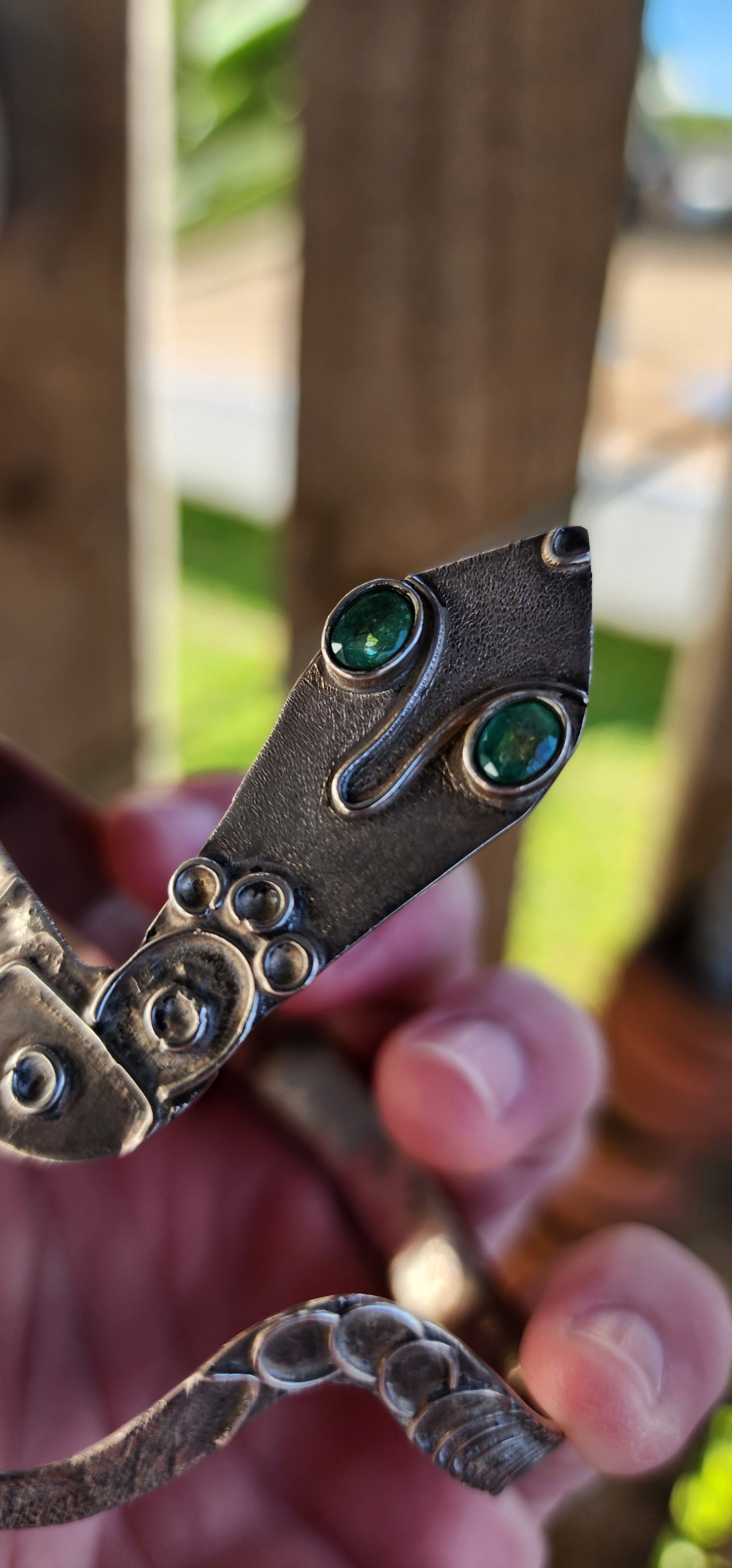 Vintage Egyptian Revival Arts and Crafts movement upper arm Serpent bracelet - Crafted in Sterling Silver with a embossed patterned body/tail, the Serpents eyes have been set with Natural Oval cut Emeralds in bezel/tube settings.