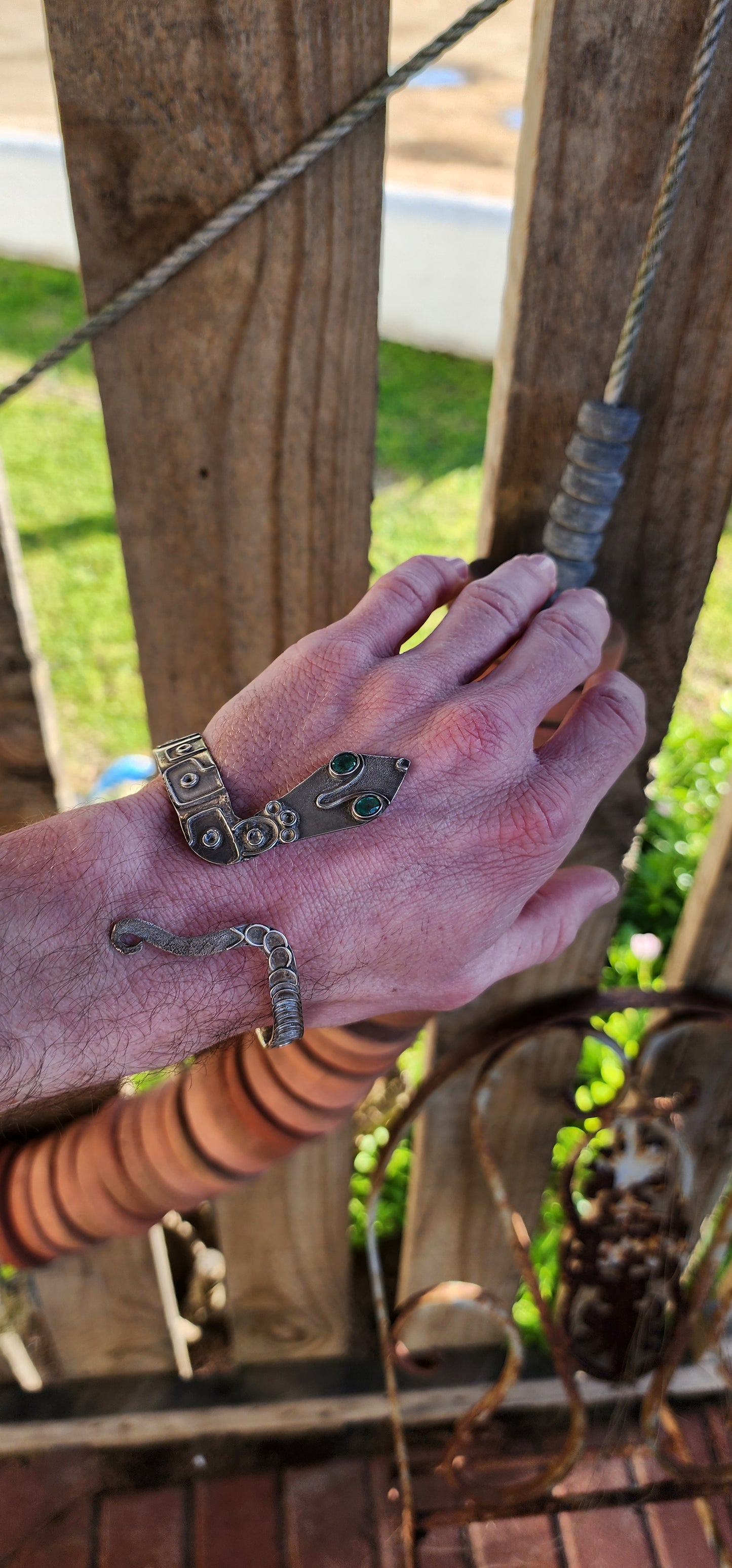 Vintage Egyptian Revival Arts and Crafts movement upper arm Serpent bracelet - Crafted in Sterling Silver with a embossed patterned body/tail, the Serpents eyes have been set with Natural Oval cut Emeralds in bezel/tube settings.