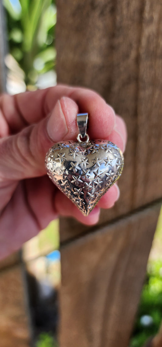 Chunky Vintage Sterling Silver, two-sided, repousse puffy Heart pendant featuring clusters of embossed Stars on both sides.