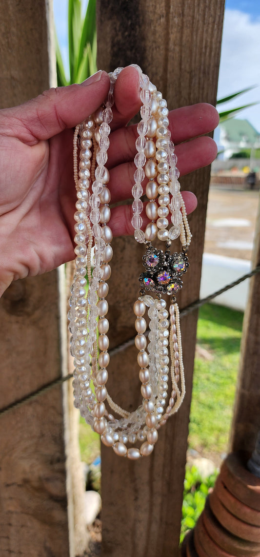 Vintage beauty ! A lovely Vintage 80's 7x strand costume beaded necklace , the beads include faux Pearls , Seed beads and clear Resin beads.