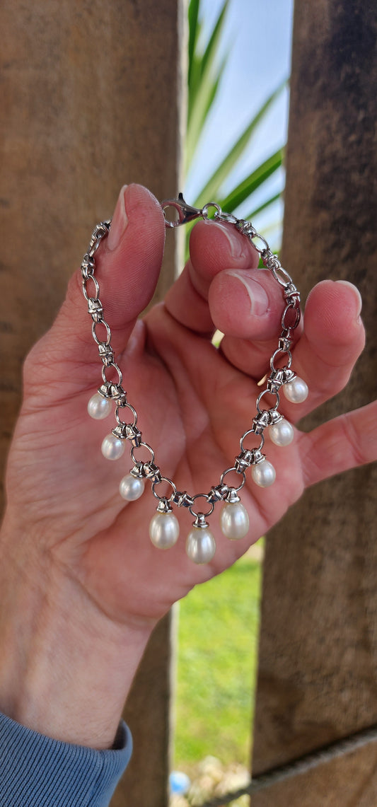 Classical beauty ! Sterling Silver fancy link bracelet adorned with 9x Teardrop Freshwater Pearl drop charms in graduated sizes.