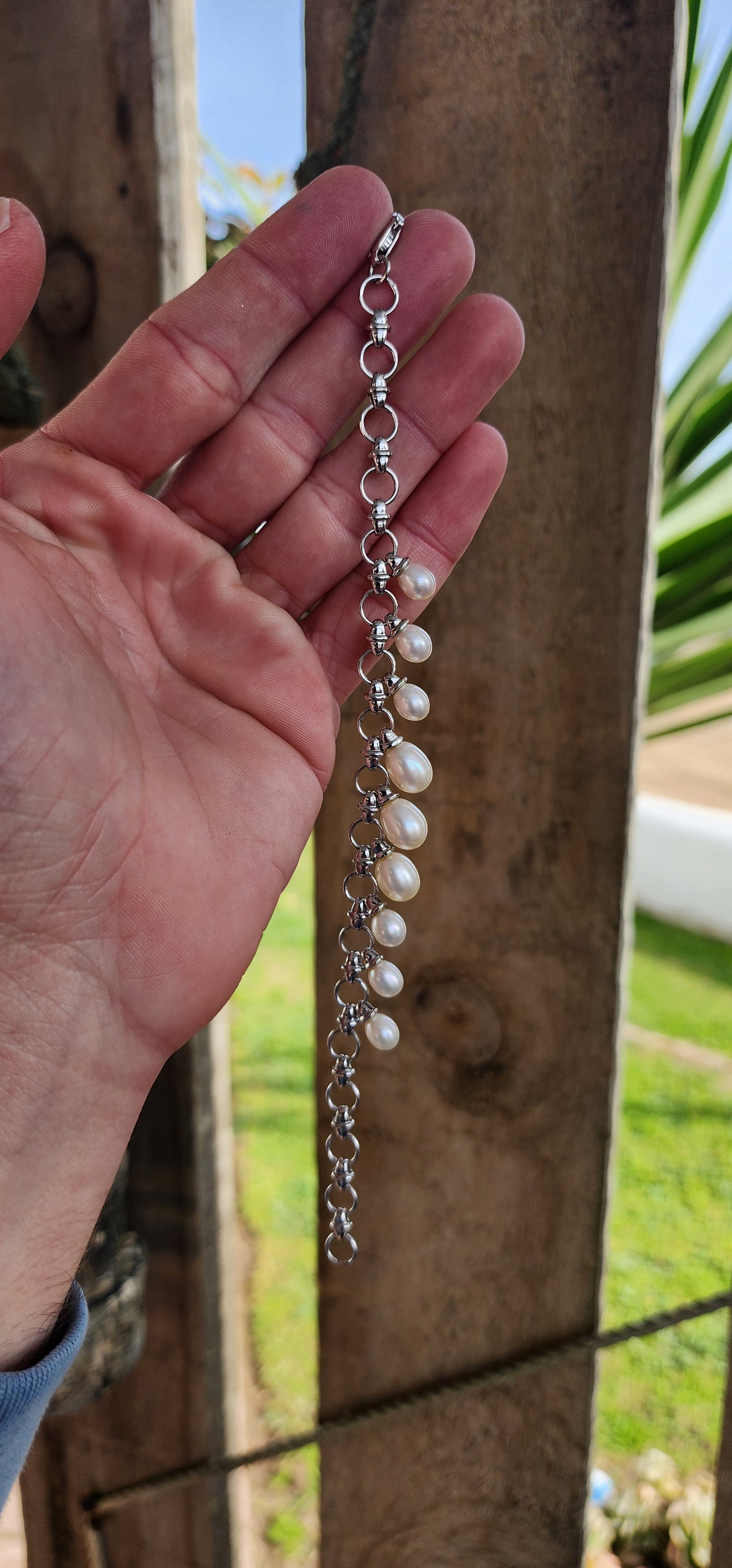 Classical beauty ! Sterling Silver fancy link bracelet adorned with 9x Teardrop Freshwater Pearl drop charms in graduated sizes.