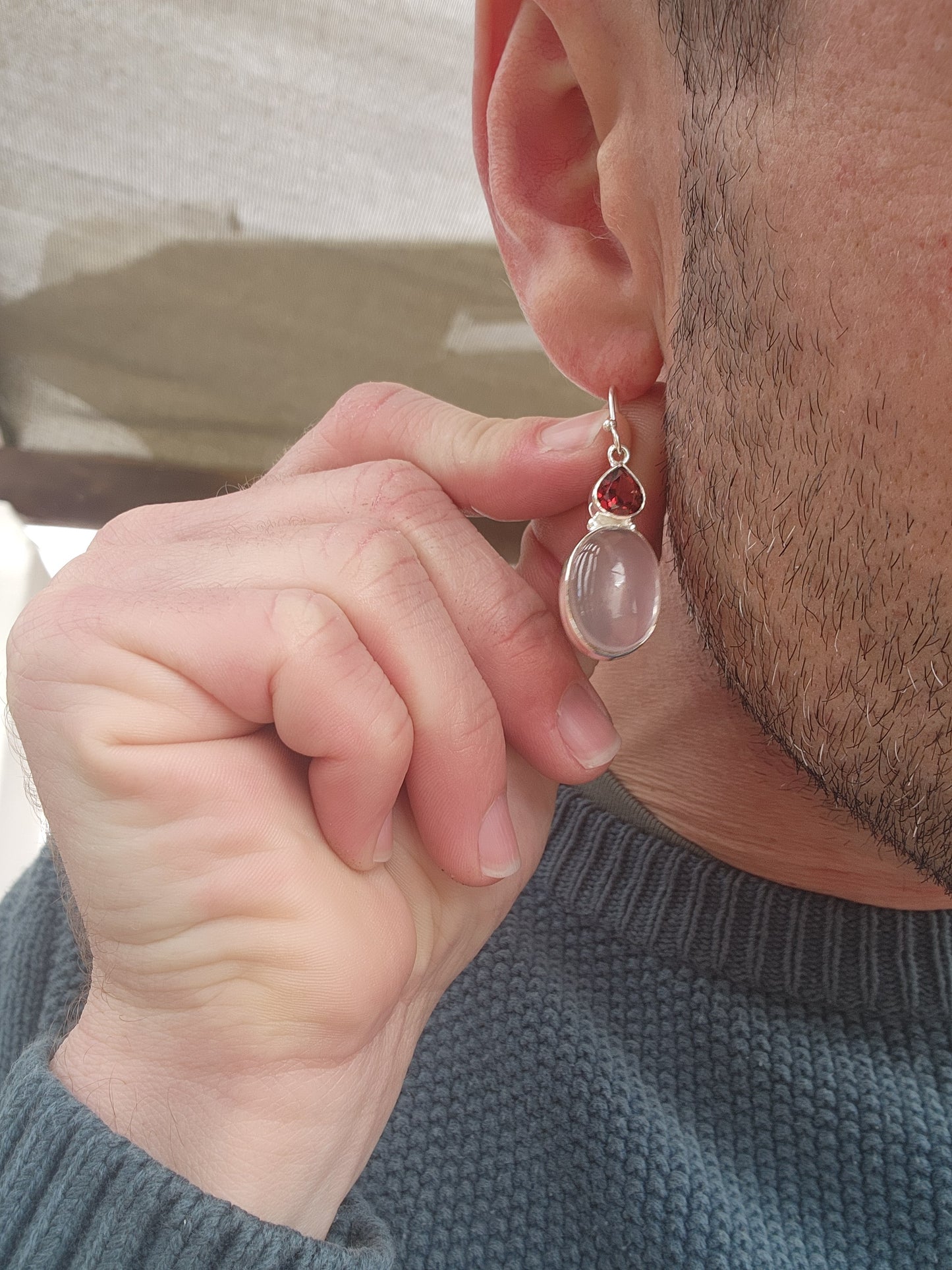 Elegant pair of Sterling Silver drop earrings.The earrings feature generous in size Oval Rose Quartz cabochon drops that are bezel/tube set ,suspended from bezel/tube set faceted Trilion cut Garnet Gemstones.