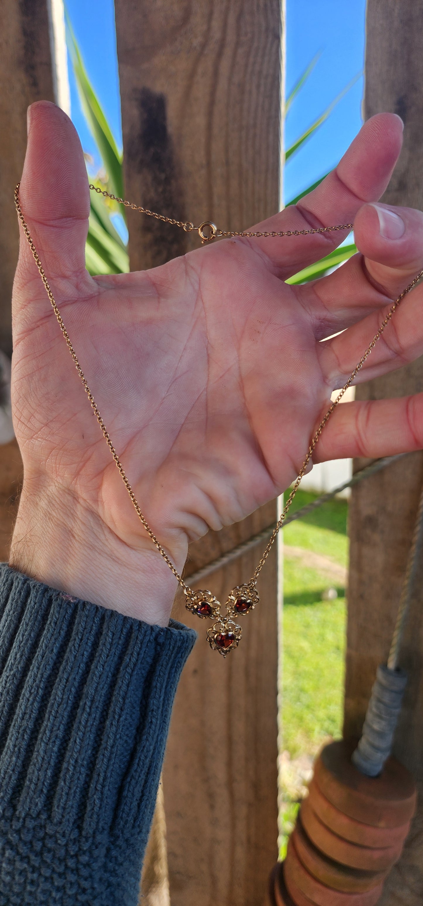 The most beautiful and petite necklace designed in a glorious Antique style.
Crafted in Sterling Silver with 18ct Yellow Gold plating, the necklace features triple jointed Heart pendants ,each pendant bezel/tube set with a fancy Heart cut Garnet.