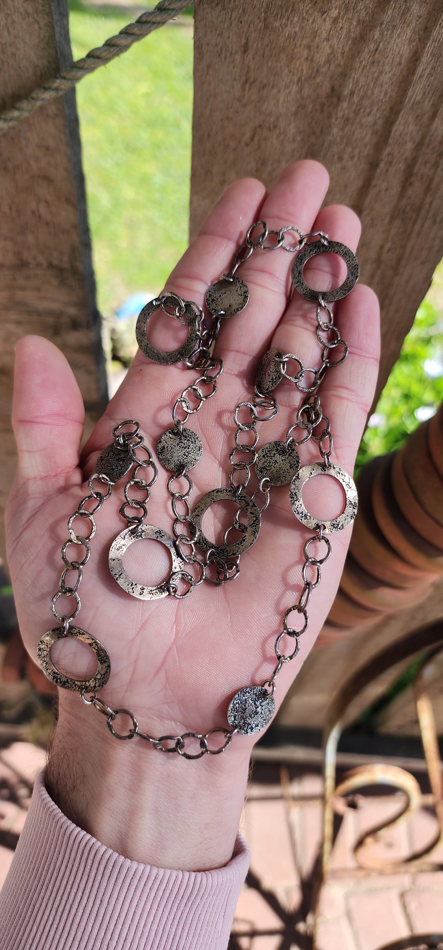 Amazing Vintage extra length Studio made Modernist/Brutalist Sterling Silver claspless necklace.The necklace comprising out of textured/hammered and patinated open Circle and disck links jointed by textured/hammered chains.