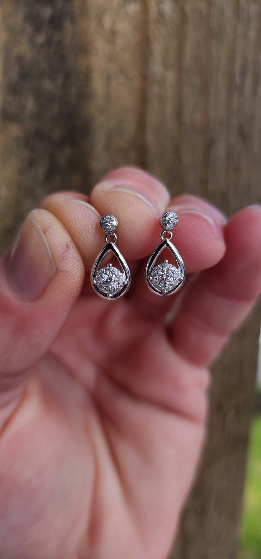 Easy and elegant, these Diamond drop earrings are perfect for that special evening out. Crafted in polished 10ct White Gold, each pear-shaped frame houses a Round cluster of shimmering Diamonds at its centre.