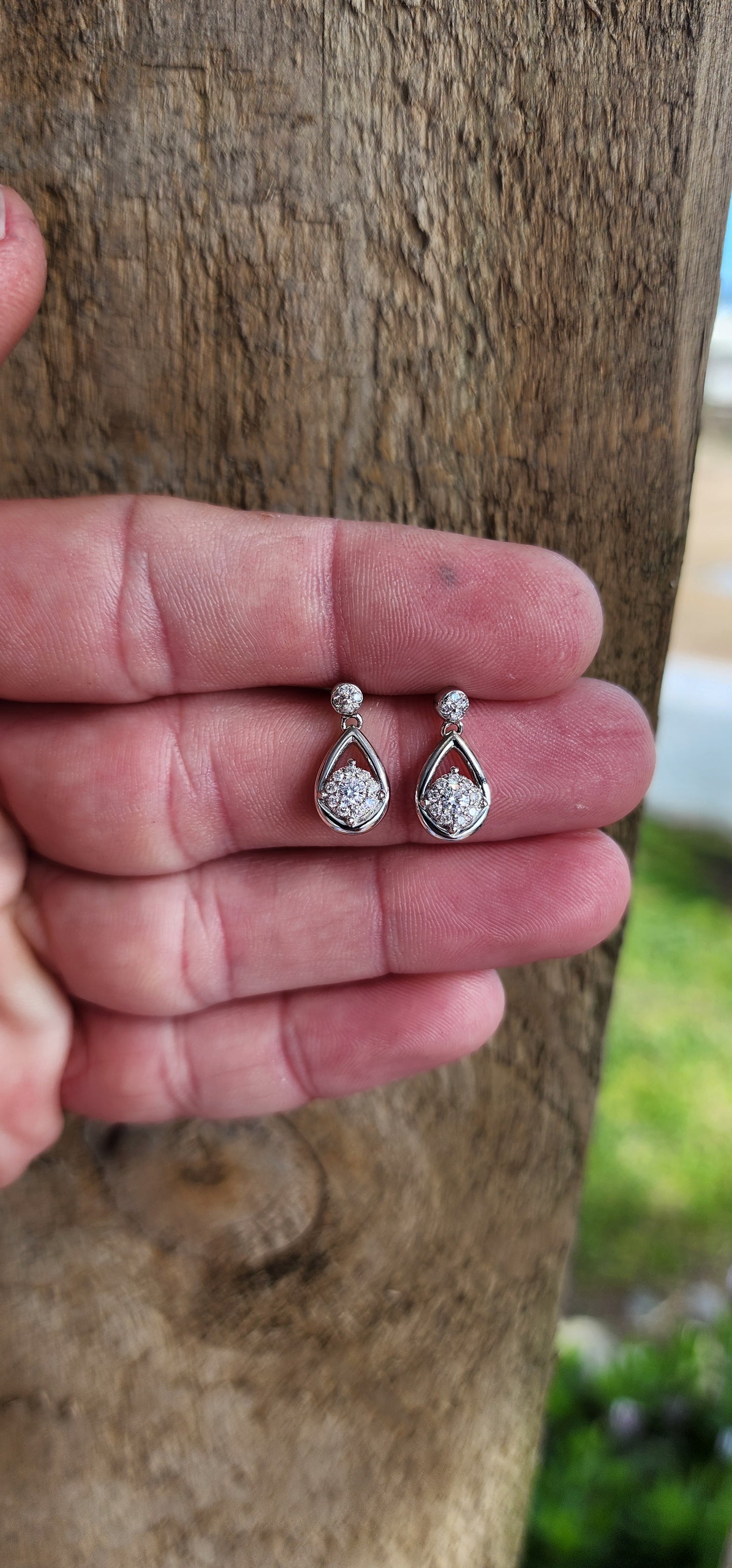 Easy and elegant, these Diamond drop earrings are perfect for that special evening out. Crafted in polished 10ct White Gold, each pear-shaped frame houses a Round cluster of shimmering Diamonds at its centre.