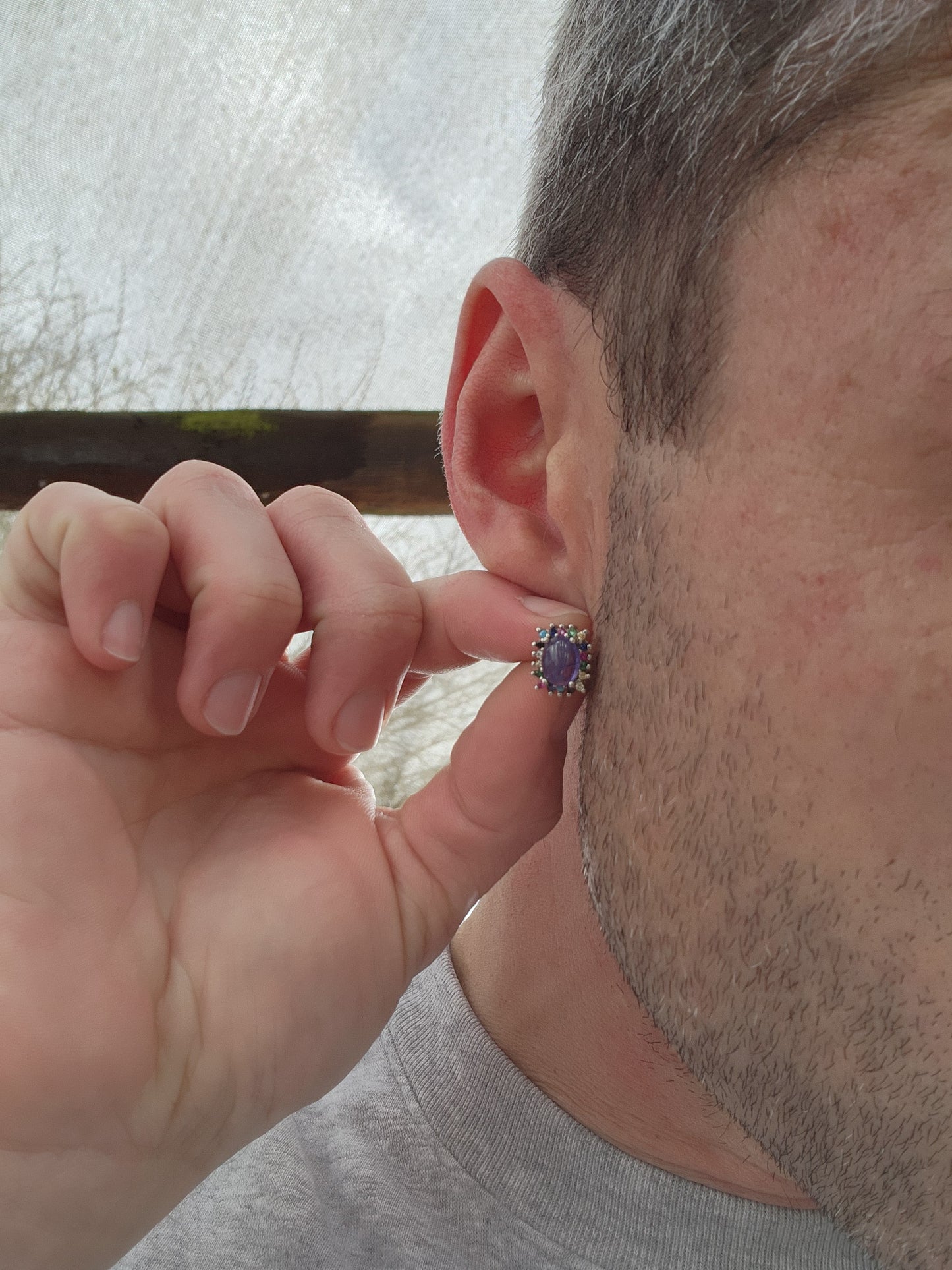 Extremely beautiful and elegant pair of Sterling Silver stud earrings - Each Earring claw set with a Natural Tanzanite Cabochon in the centre and surrounded by a muticolor Gemstones Haló frame of small Round cut Gemstones.