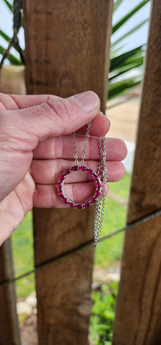 Beautiful and elegant Circle of life pendant on chain.A halo of Natural Oval cut Ruby Gemstones in prong settings,finely arranged in an Sterling Silver open Circle design.