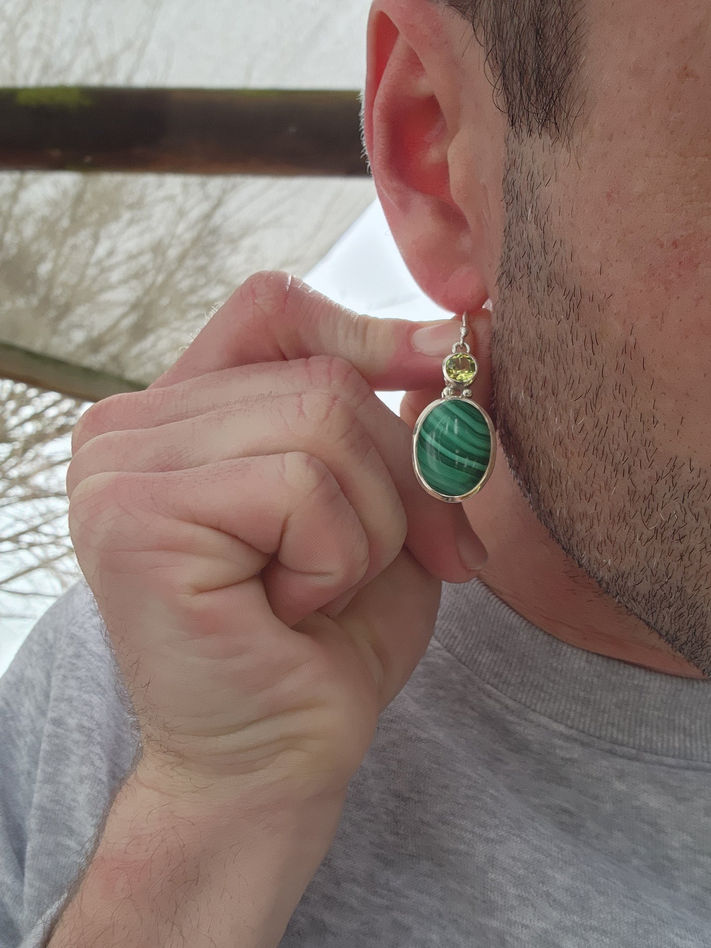 These lovely Sterling Silver dangle earrings are the perfect go to for any jewelry collection. They feature bezel/tube set oval Malachite cabochons suspended from Round faceted cut Peridot Gemstones in bezel/tube settings.