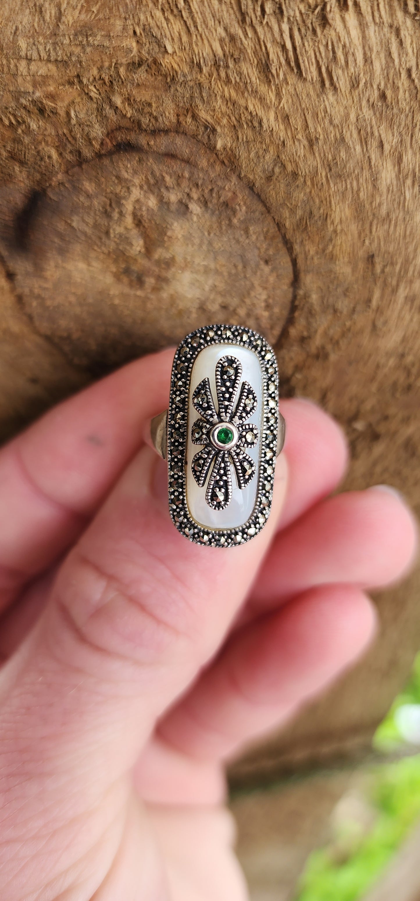 Art Deco style Sterling silver ring bezel/tube set with a Rectangular shaped Mother of Pearl Cabochon, framed in a sparkly Marcasite border.