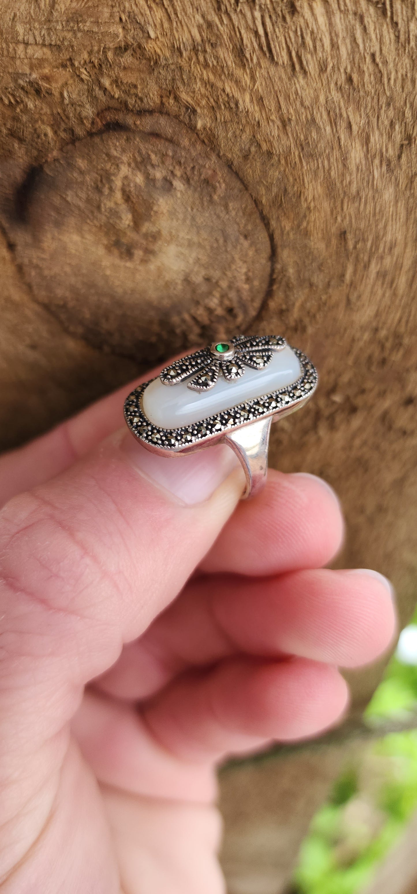 Art Deco style Sterling silver ring bezel/tube set with a Rectangular shaped Mother of Pearl Cabochon, framed in a sparkly Marcasite border.