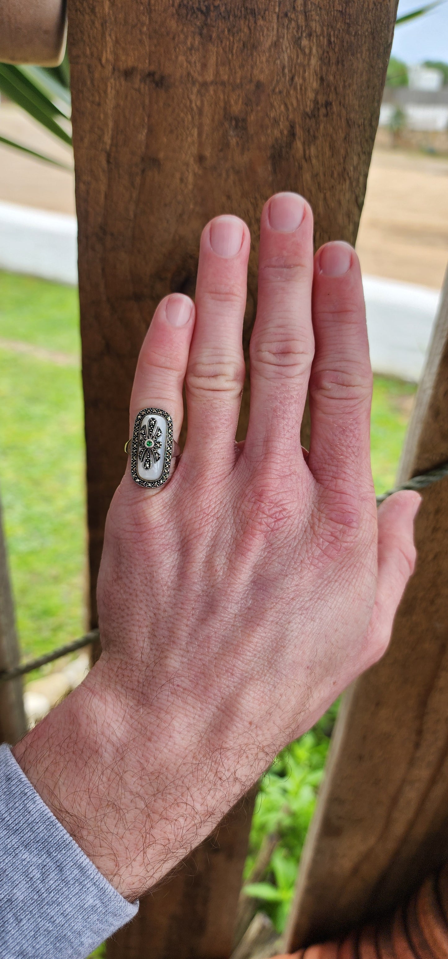 Art Deco style Sterling silver ring bezel/tube set with a Rectangular shaped Mother of Pearl Cabochon, framed in a sparkly Marcasite border.