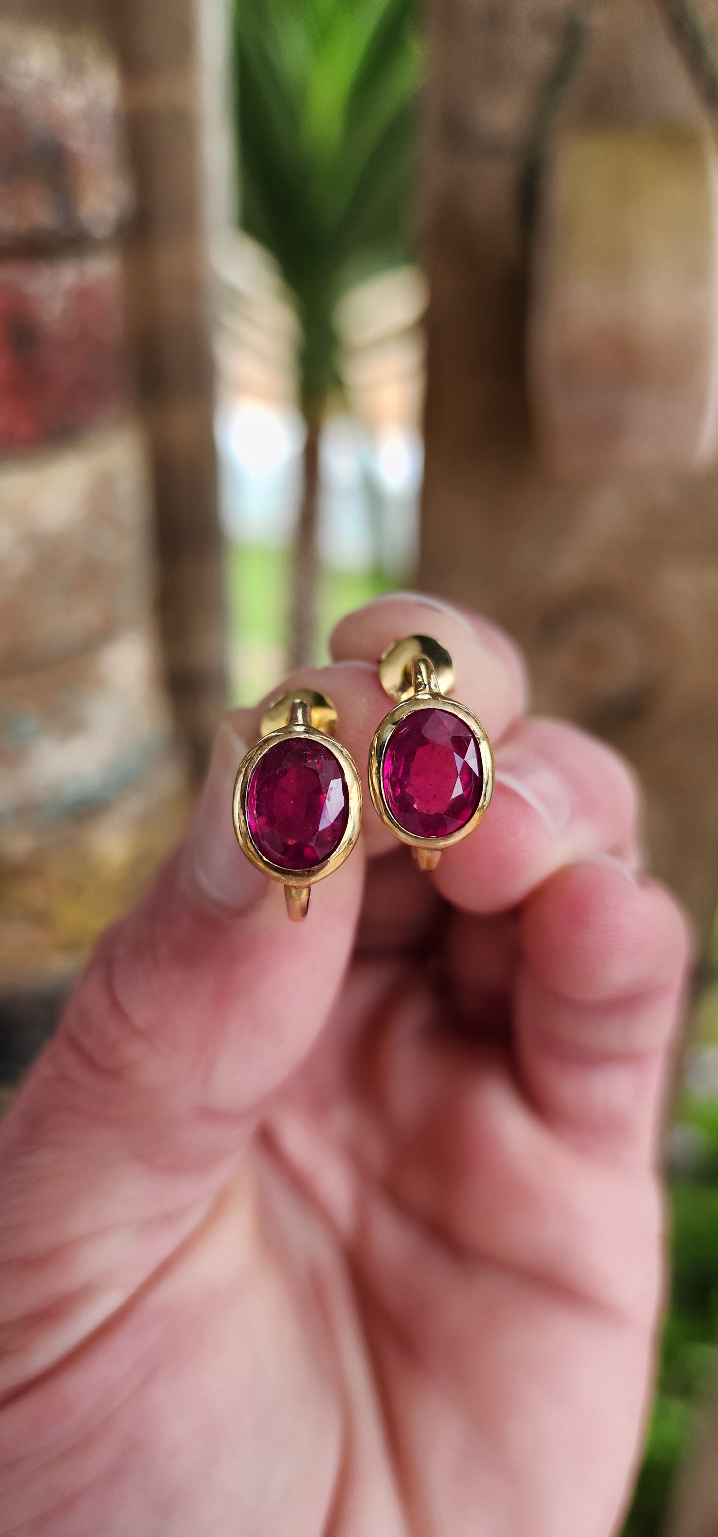 Modernist in style pair of Sterling Silver with 18ct Yellow Gold plating half hoop stud earrings - Each earring bezel/tube set with a generous in size Oval faceted cut Red Rubellite Tourmaline Gemstone.