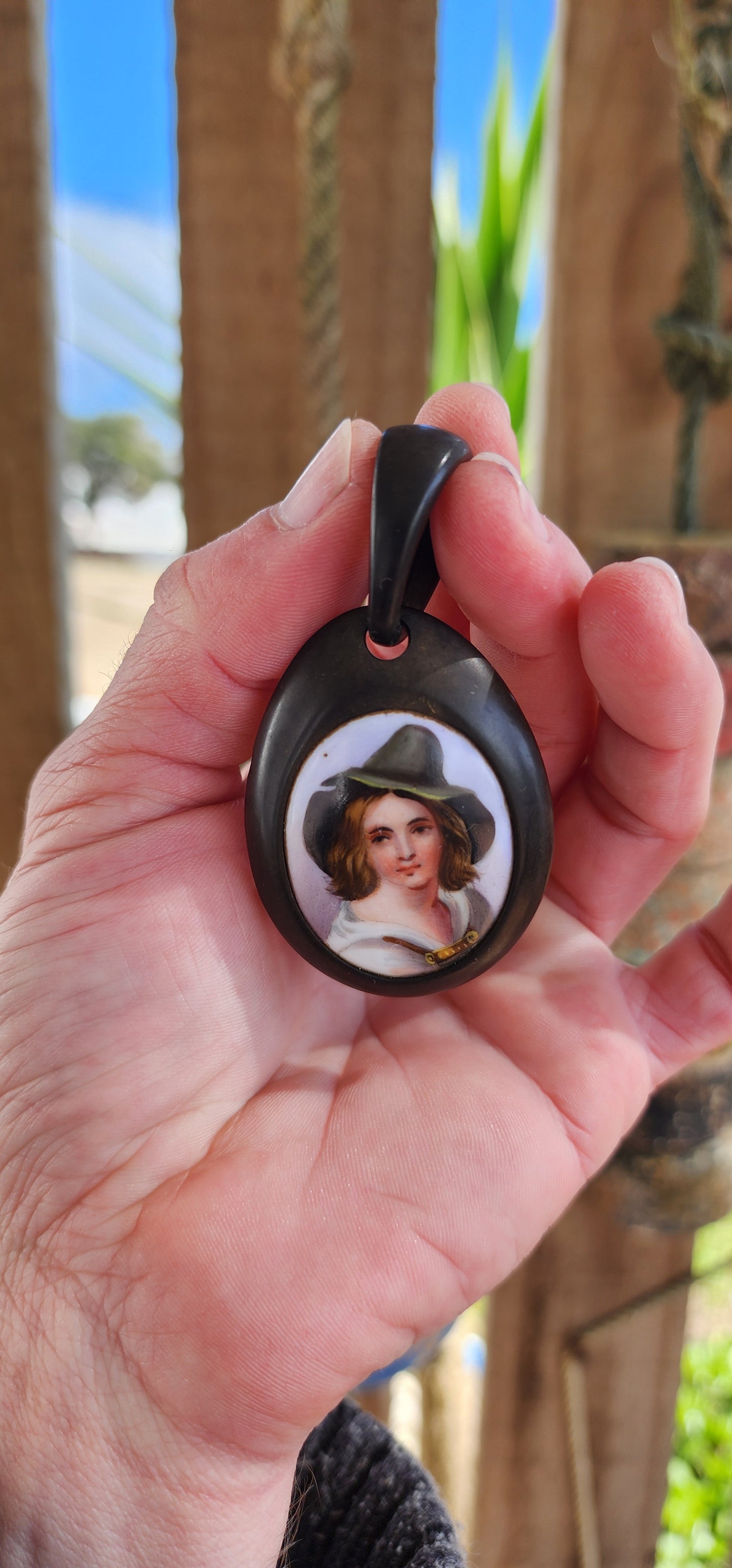 Antique Victorian circa 1890's Vulcanite and hand painted porcelain pendant.
The very detailed hand painted portrait featuring a Tyrolean Boy with Green hat.