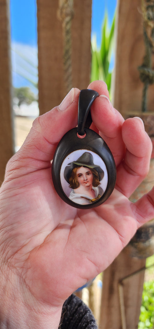 Antique Victorian circa 1890's Vulcanite and hand painted porcelain pendant.
The very detailed hand painted portrait featuring a Tyrolean Boy with Green hat.