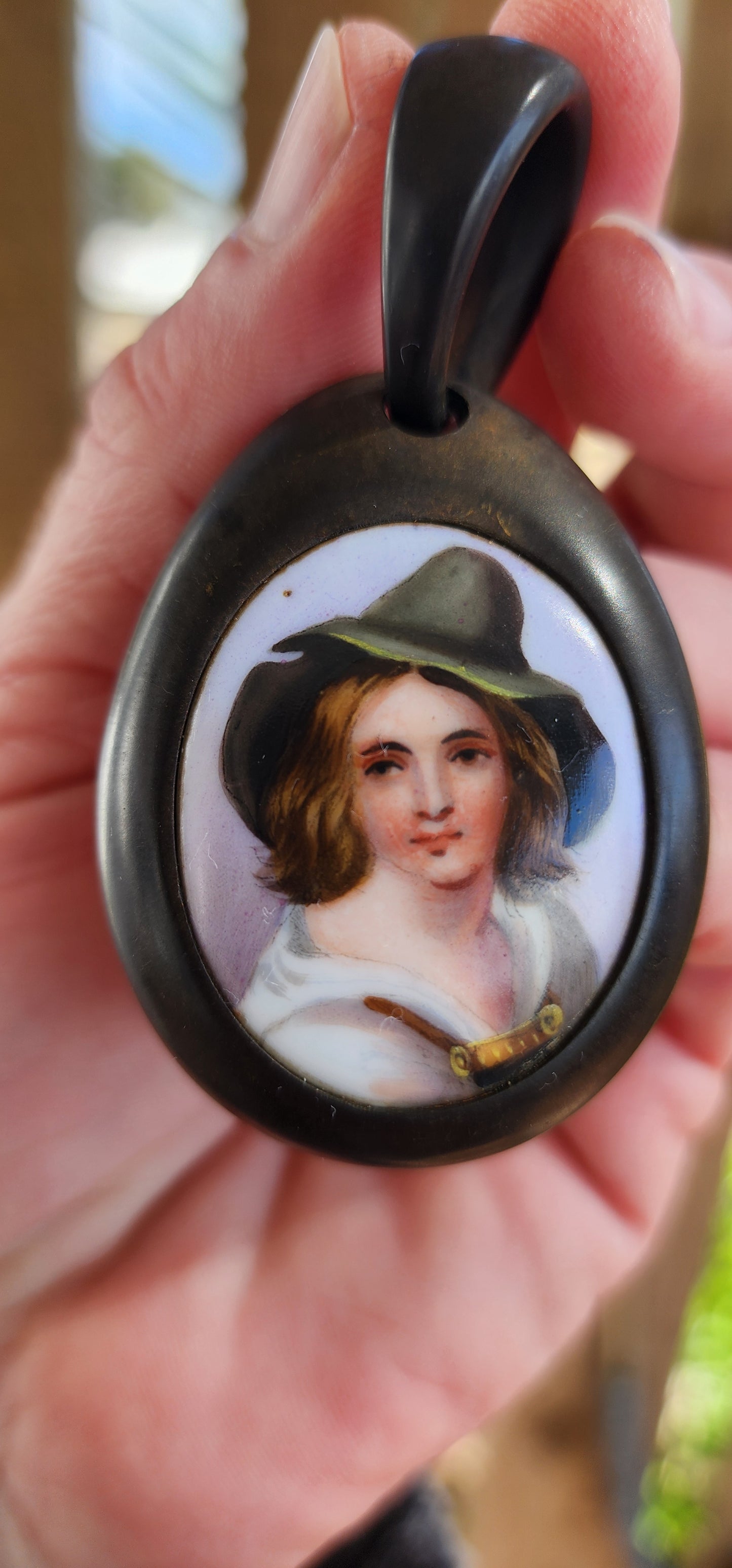 Antique Victorian circa 1890's Vulcanite and hand painted porcelain pendant.
The very detailed hand painted portrait featuring a Tyrolean Boy with Green hat.