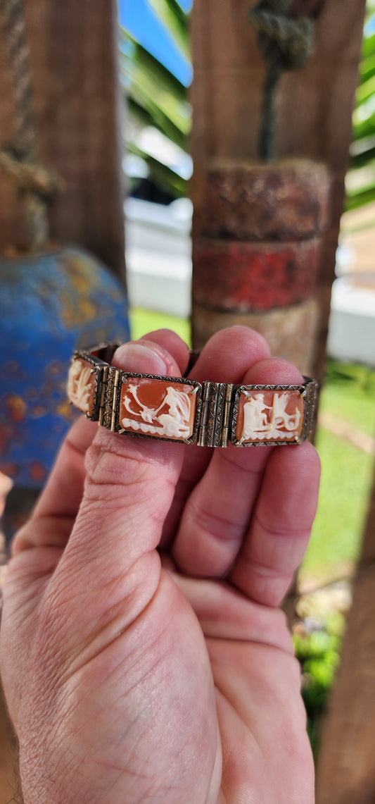 An extraordinary and rare Antique Victorian  Italian Sardonyx Cameo Mythology 7-panel bracelet. Hand-carved and in a lovely 800 silver setting, this bracelet features stunning scenes of Roman gods racing chariots representing the days of the week.