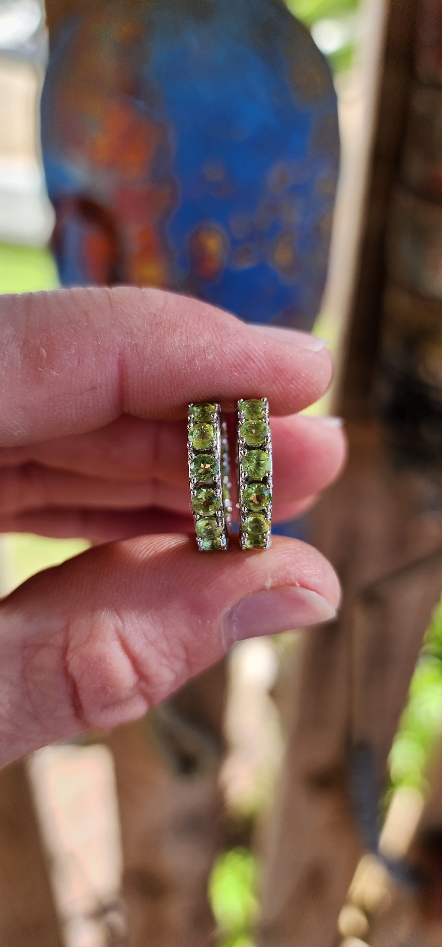 Gorgeous pair of Sterling Silver and Green Peridot Gemstones Huggies/Hoop earrings .Each earring set with 10x Round Faceted Cut Peridot Gemstones.