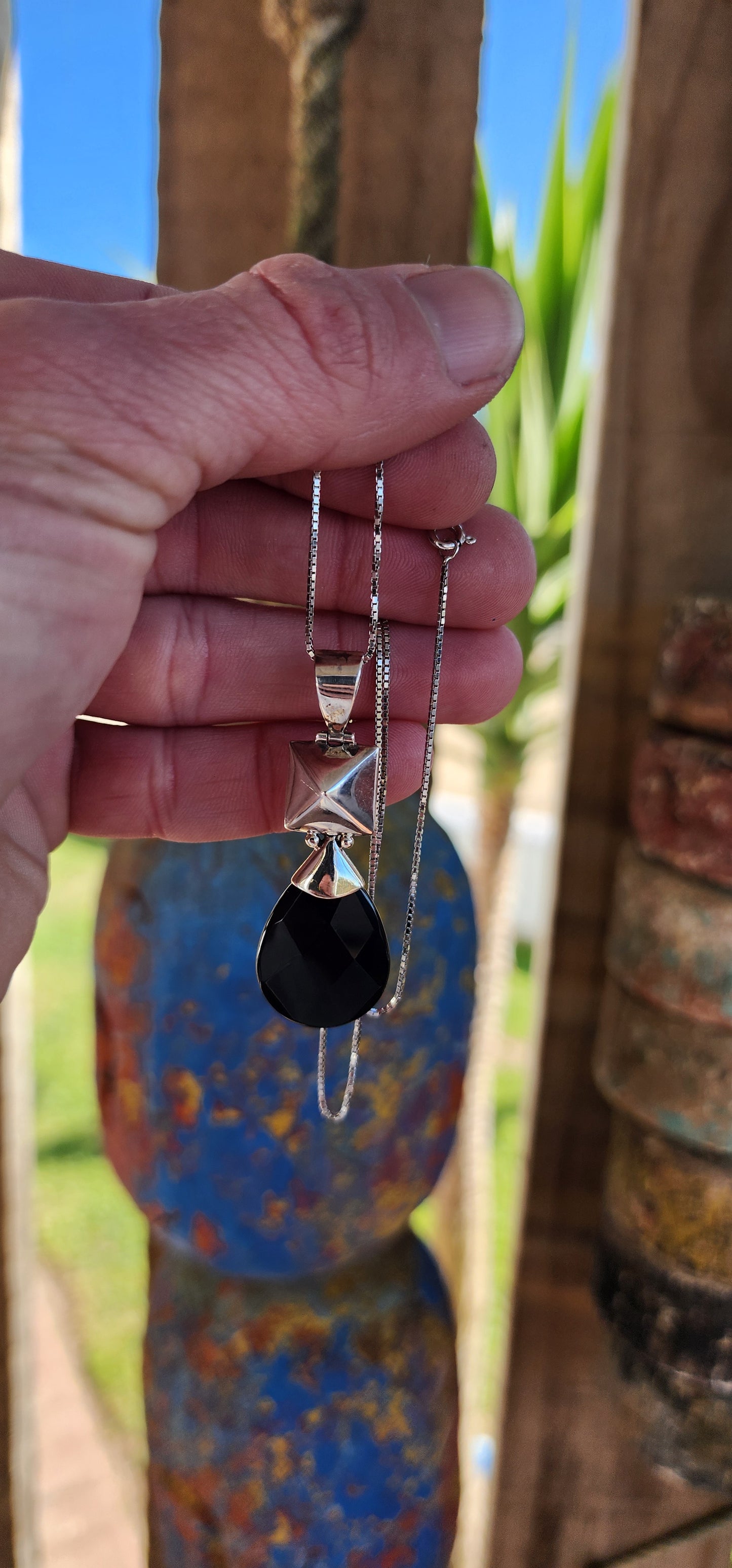 Modernist in design Sterling Silver and Onyx Gemstone double sided pendant.A lovely checkerboard faceted Pear cut Black Onyx drop suspended from a hollow puffed Pyramid shape.The pendant comes fitted on a extra length Sterling Silver Box chain.