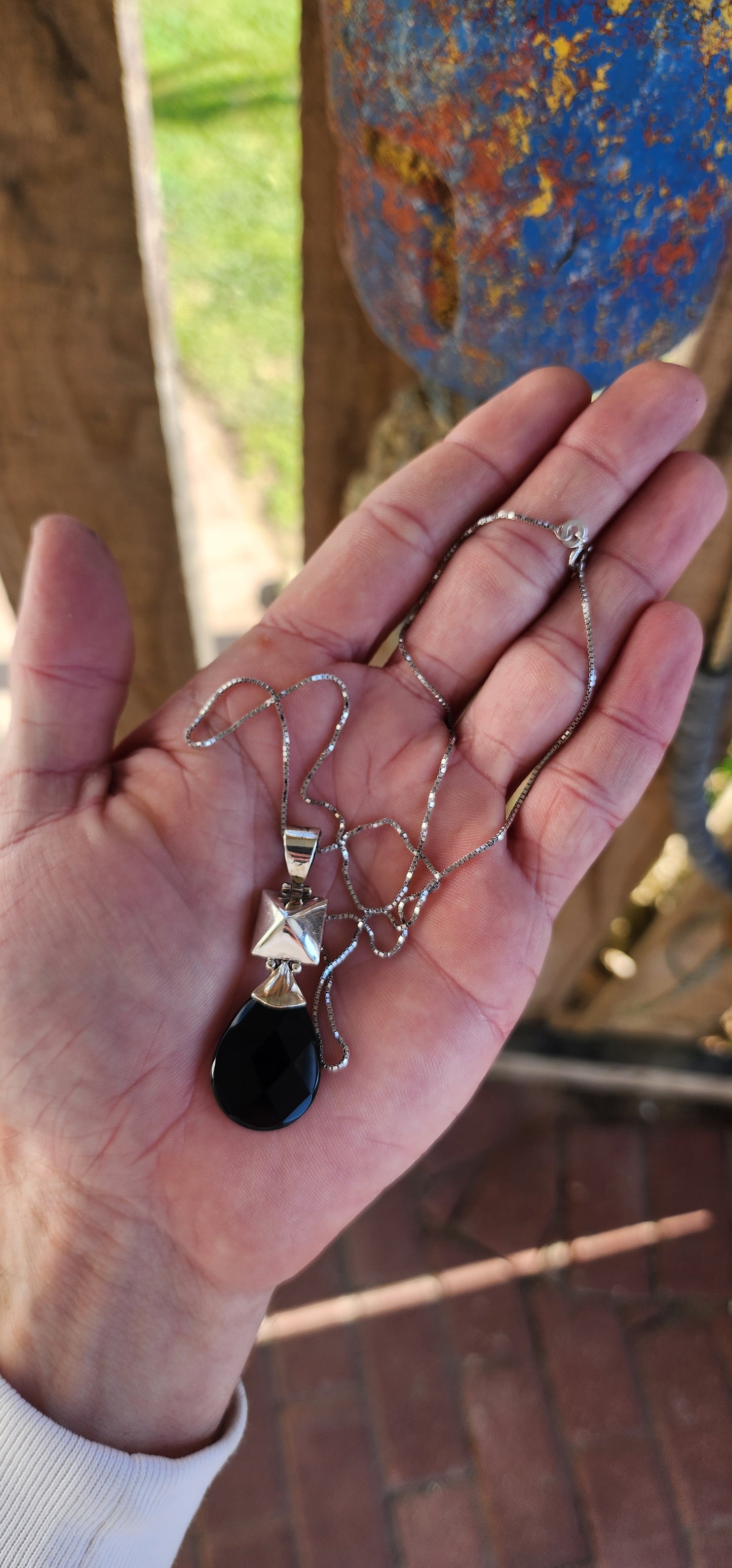 Modernist in design Sterling Silver and Onyx Gemstone double sided pendant.A lovely checkerboard faceted Pear cut Black Onyx drop suspended from a hollow puffed Pyramid shape.The pendant comes fitted on a extra length Sterling Silver Box chain.