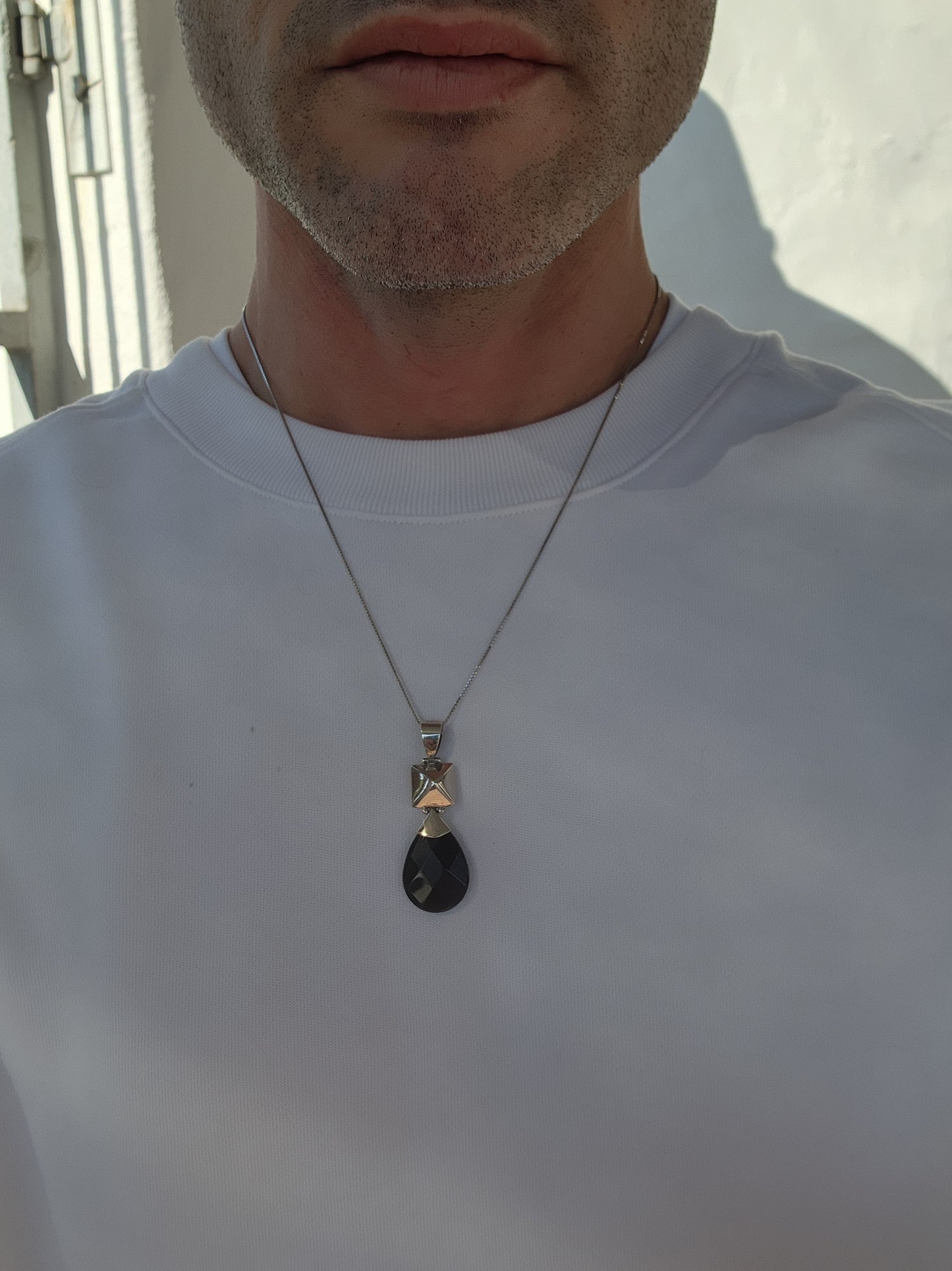 Modernist in design Sterling Silver and Onyx Gemstone double sided pendant.A lovely checkerboard faceted Pear cut Black Onyx drop suspended from a hollow puffed Pyramid shape.The pendant comes fitted on a extra length Sterling Silver Box chain.