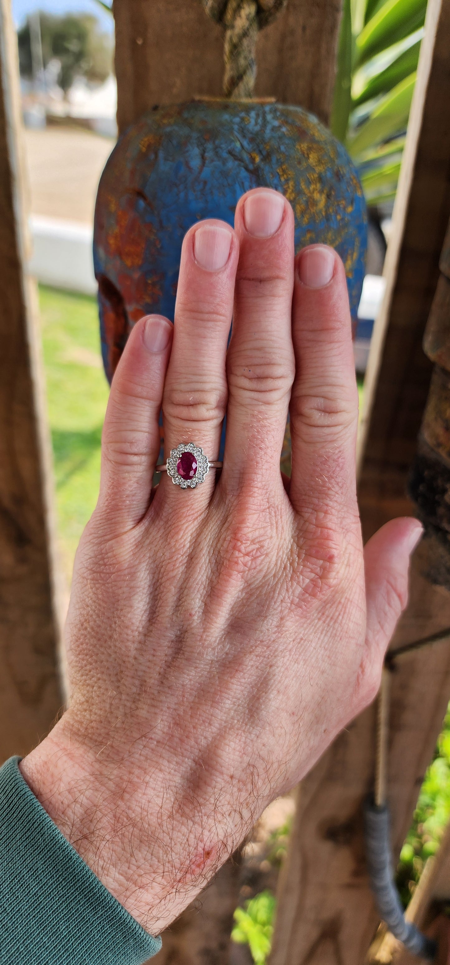 Elegant Sterling Silver, Ruby and CZ cluster/halo ring.
This lovely ring is centrally set with a Oval cut Ruby which is four claw set in Sterling Silver.