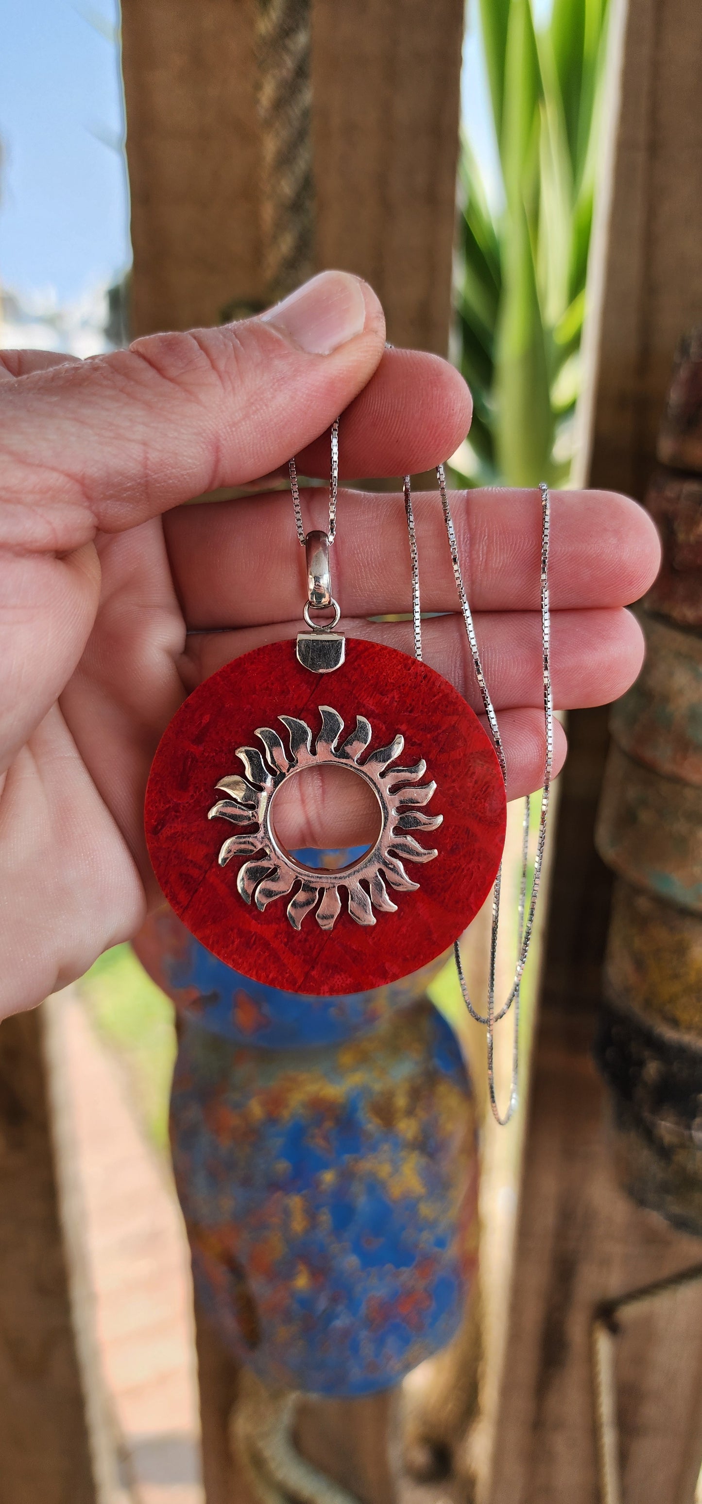 Beautiful and large sized Sterling Silver and Red Sponge Coral Circular Pendant - The open centre decorated with a Sterling Silver Sunburs pattern.
The pendant comes fitted on a extra length Sterling Silver box chain.