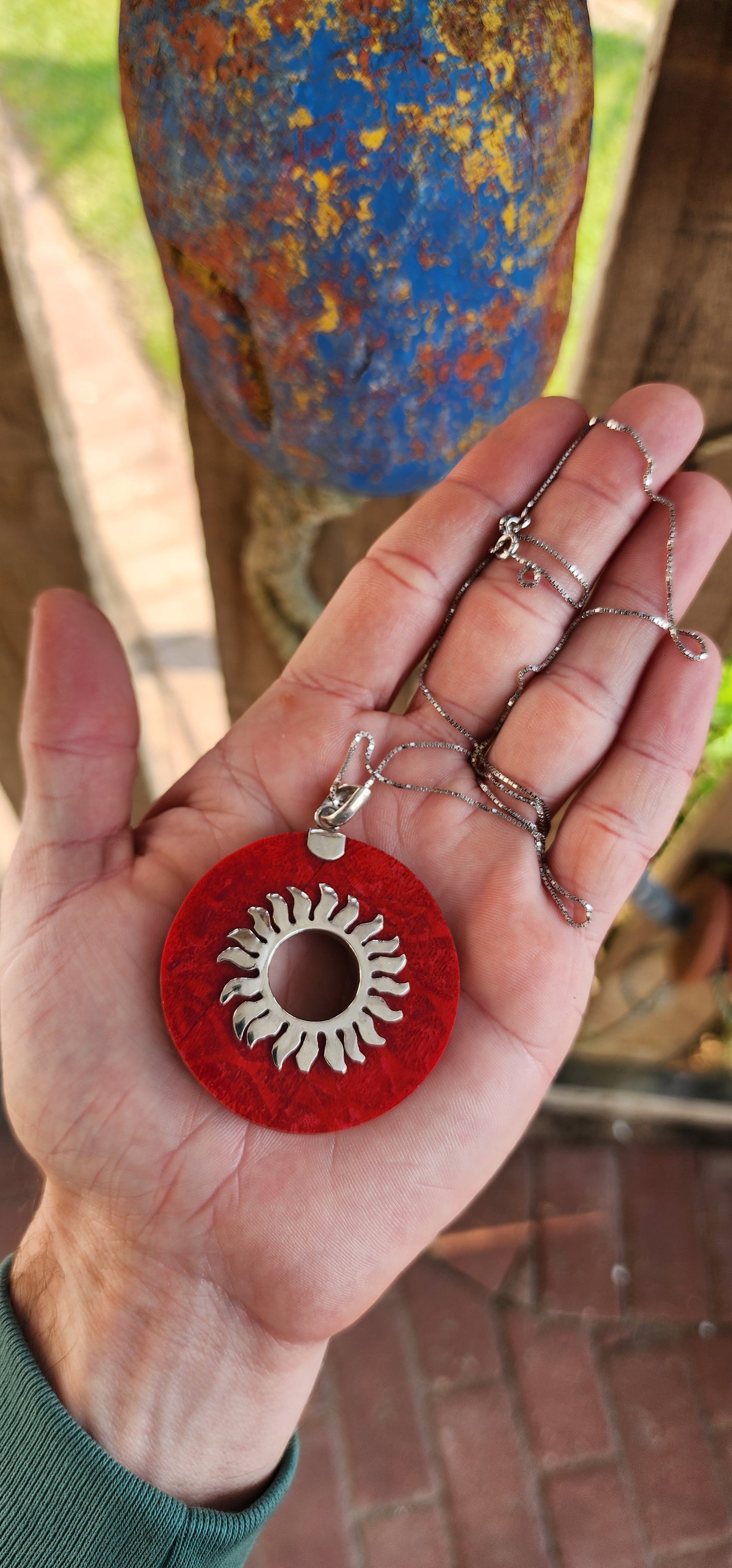 Beautiful and large sized Sterling Silver and Red Sponge Coral Circular Pendant - The open centre decorated with a Sterling Silver Sunburs pattern.
The pendant comes fitted on a extra length Sterling Silver box chain.