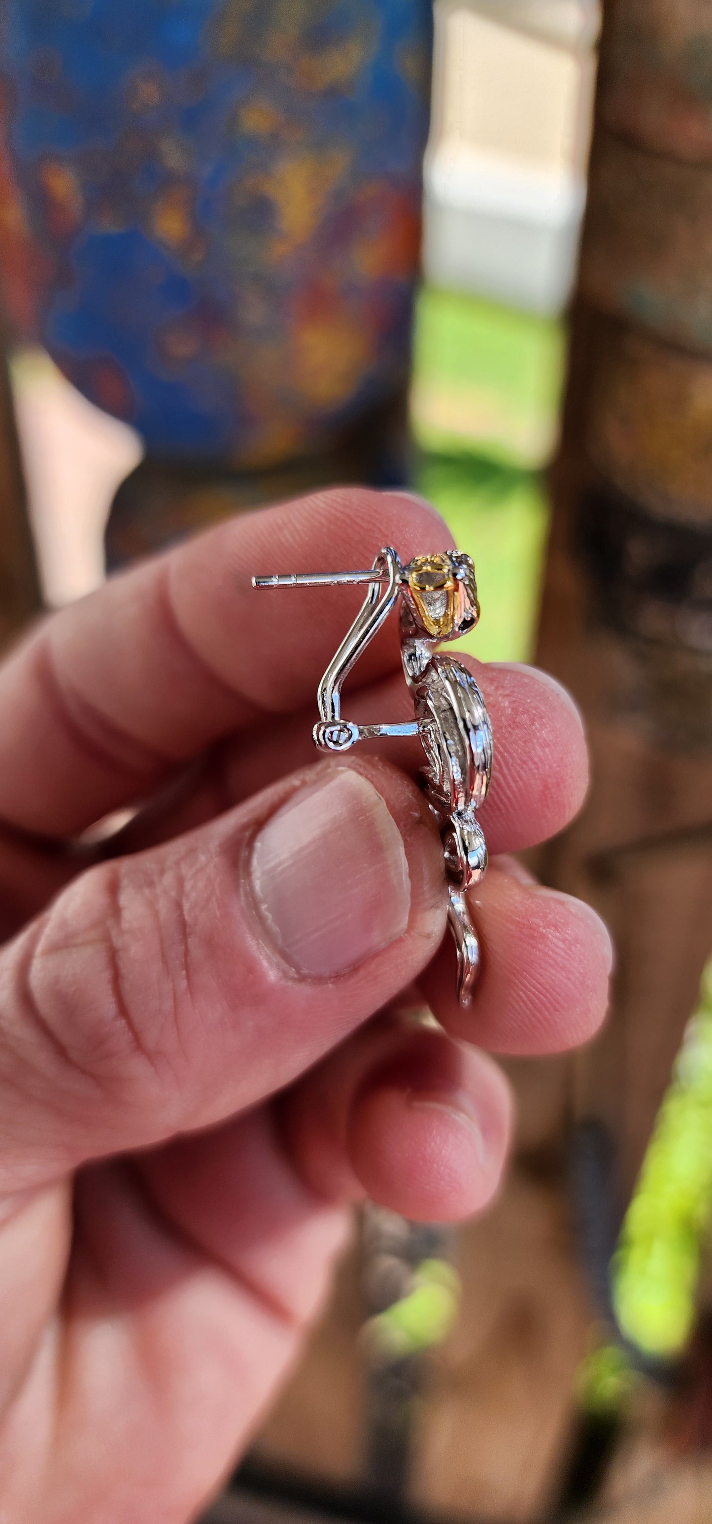 Elegantly crafted Sterling Silver coiling Serpent statement push-in earrings. The Serpents have a textured appearance on their bodies. Black flush set Spinel Gemstones highlight the eyes and body of the Serpents.